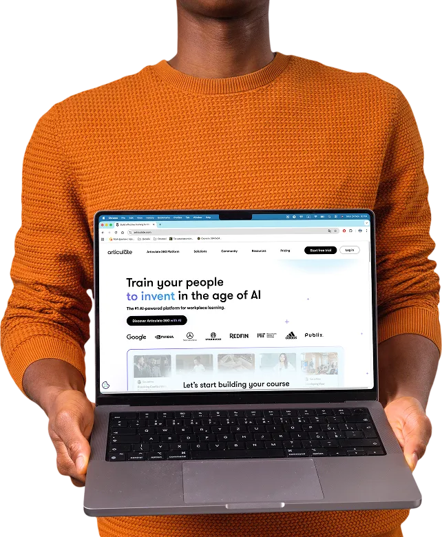 Person in orange sweater holding an open laptop showing a website with the headline 'Train your people to invent in the age of AI'.