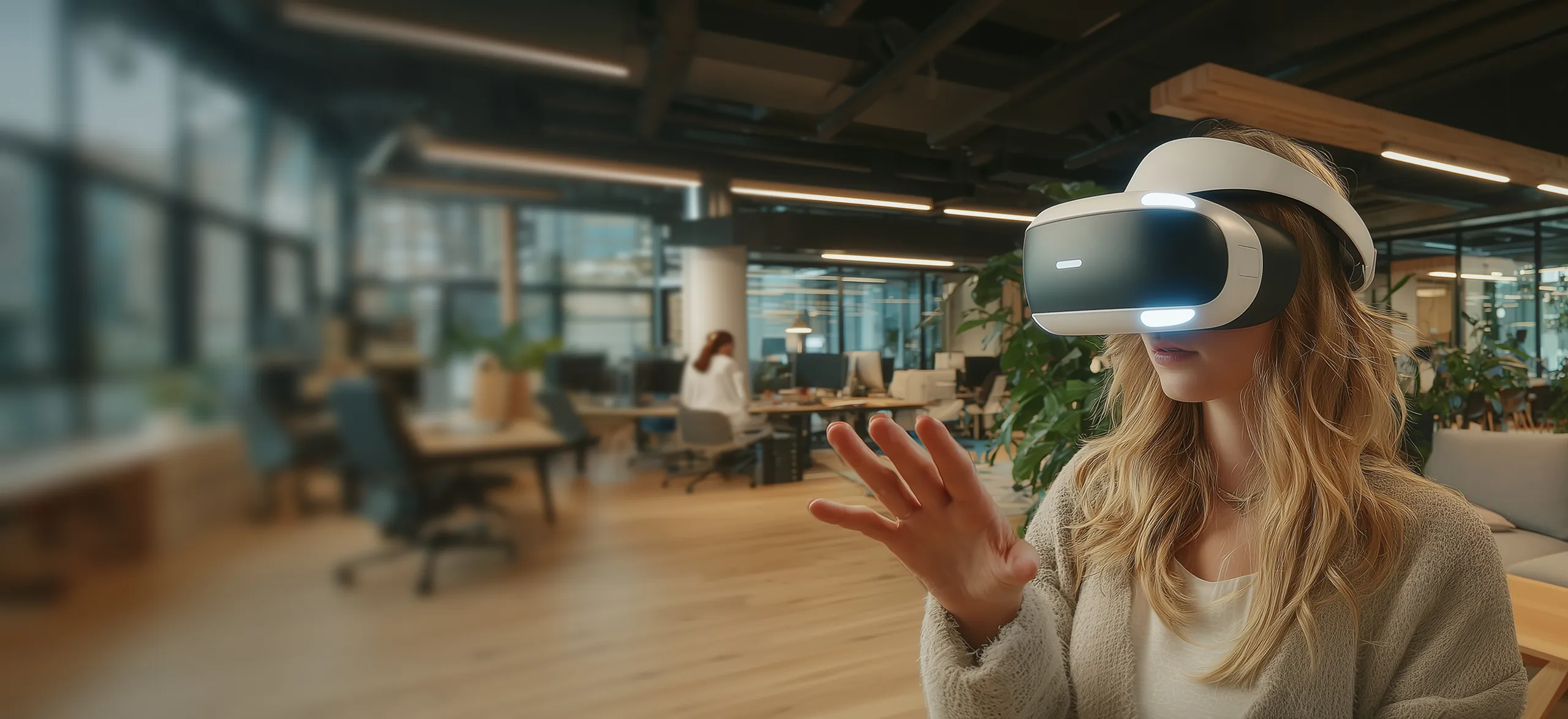 A woman wearing a virtual reality headset gestures with her hand in a modern office space.
