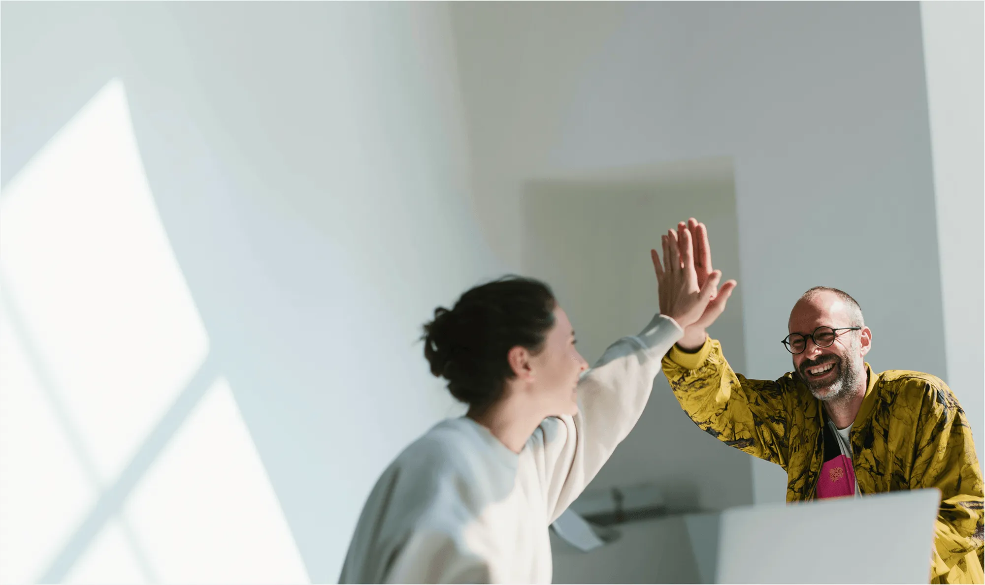 Two business people celebrating the financing success