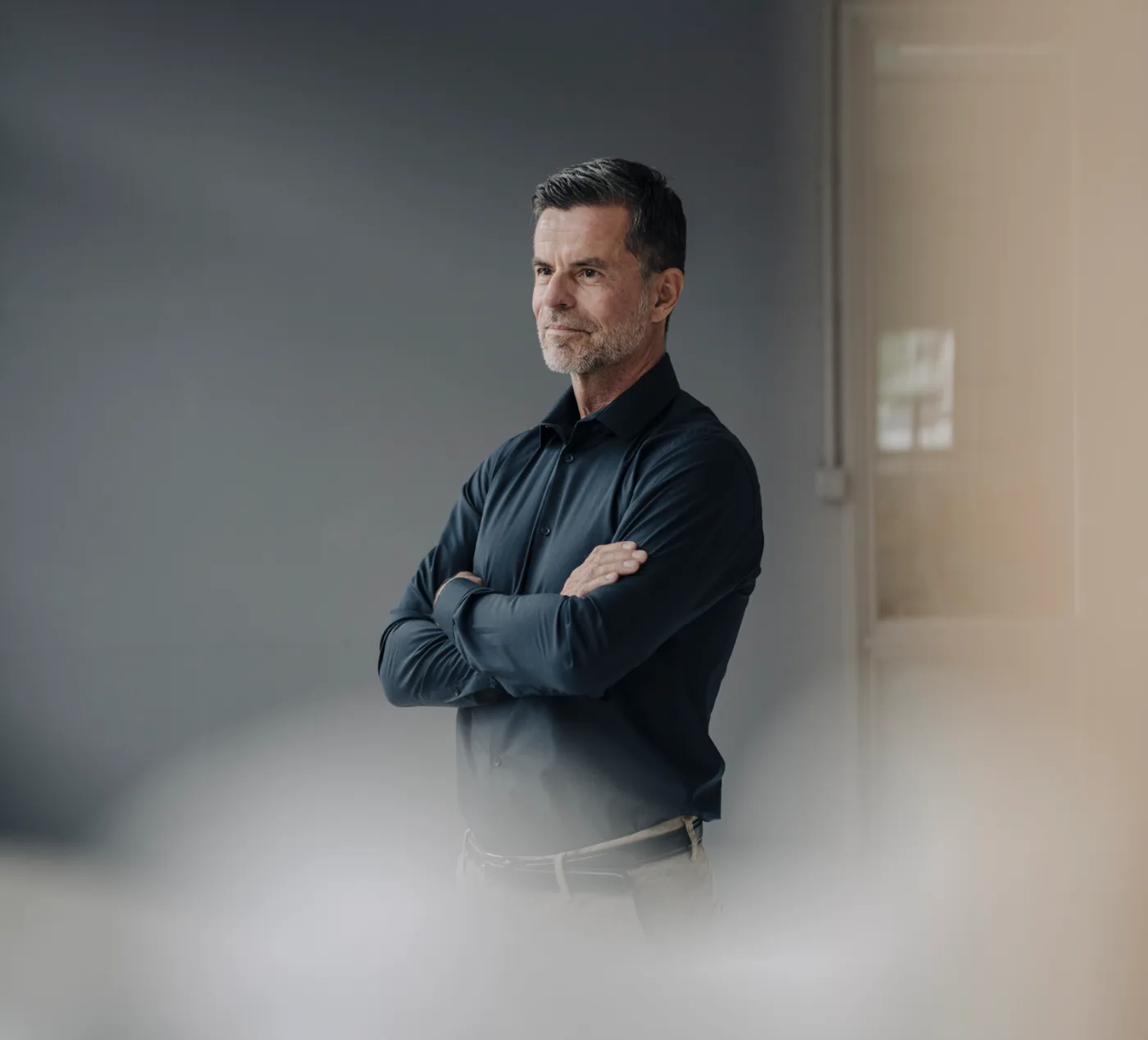 A physician standing in a clinic corridor