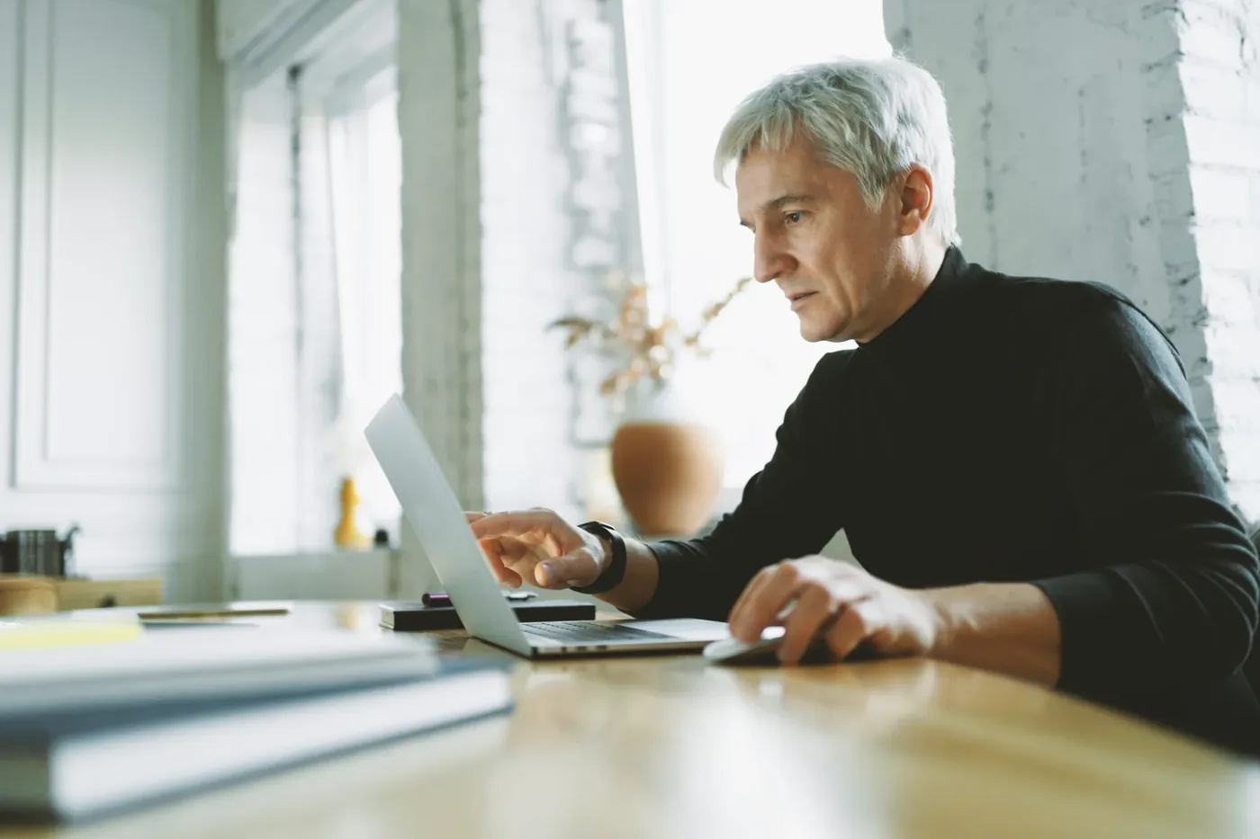 Physician reviewing a patient record on a laptop