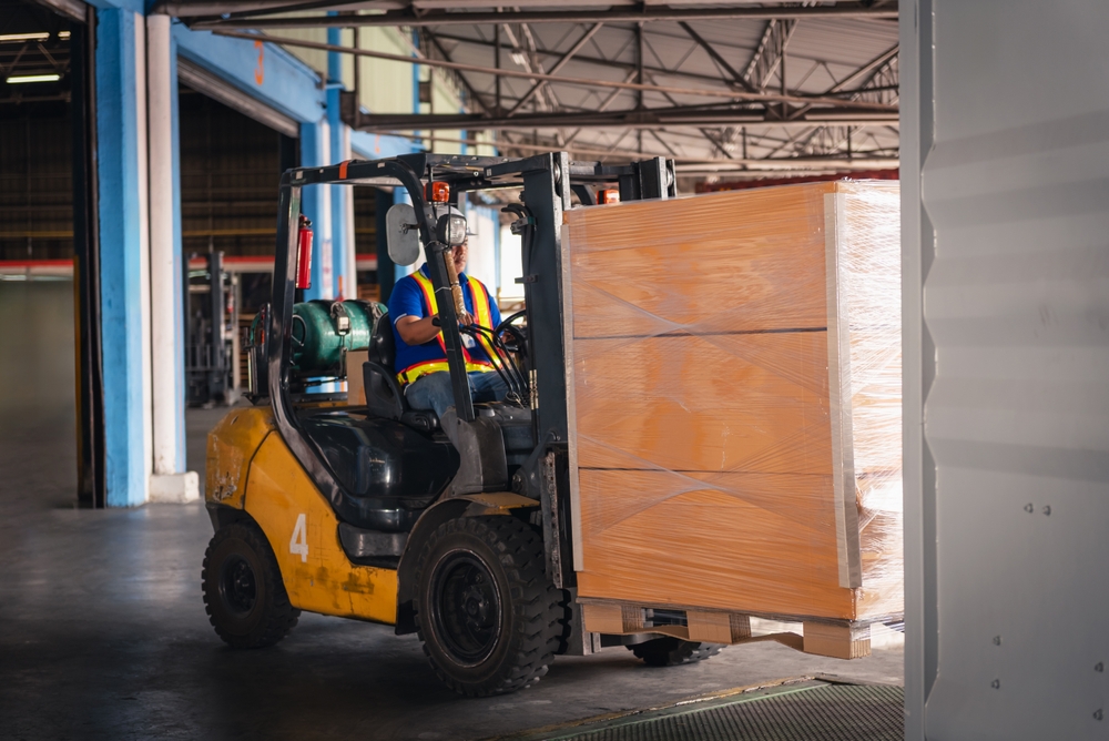 Factory worker in busy warehouse