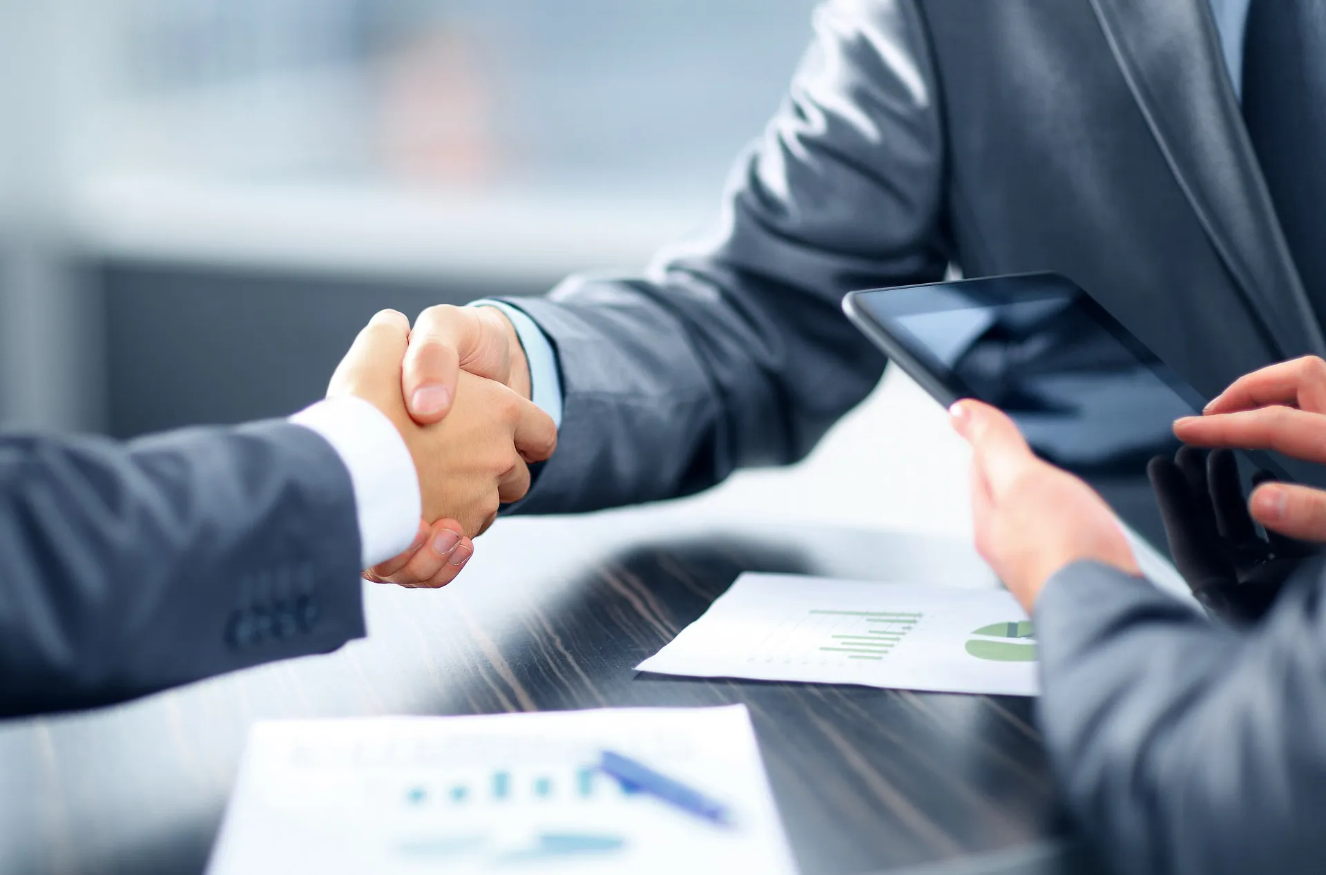 Two people shaking hands to symbolize a business agreement