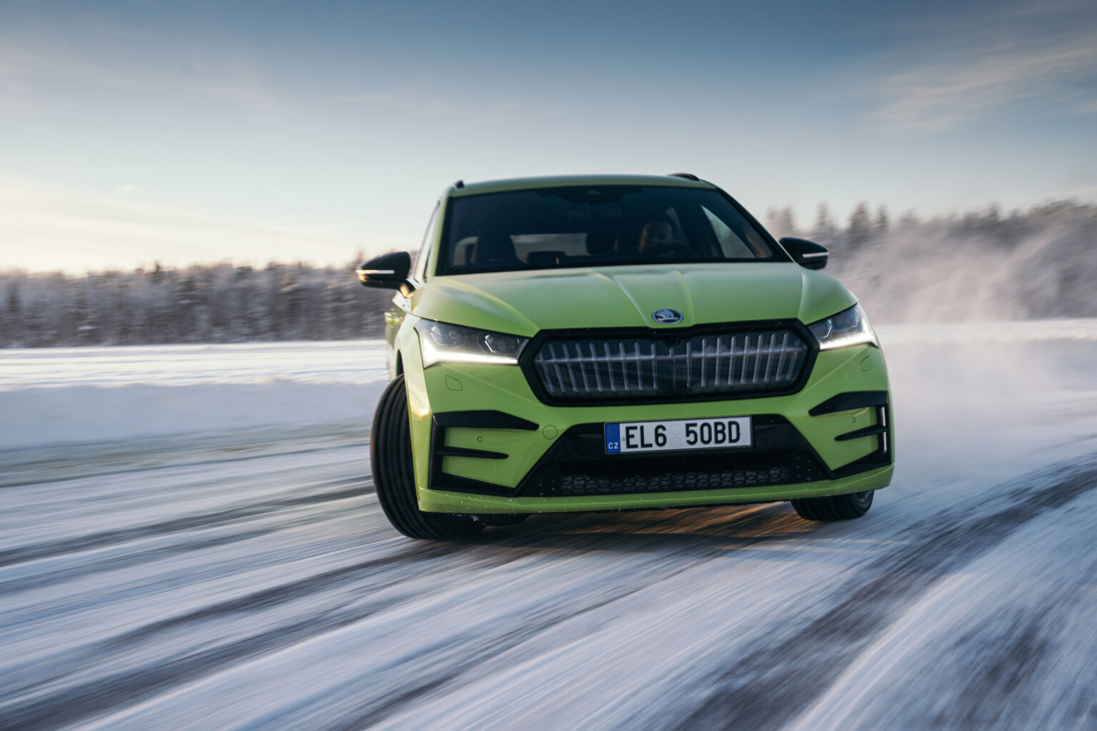 A Skoda kicking up snow while driving on ice in Östersund, Sweden