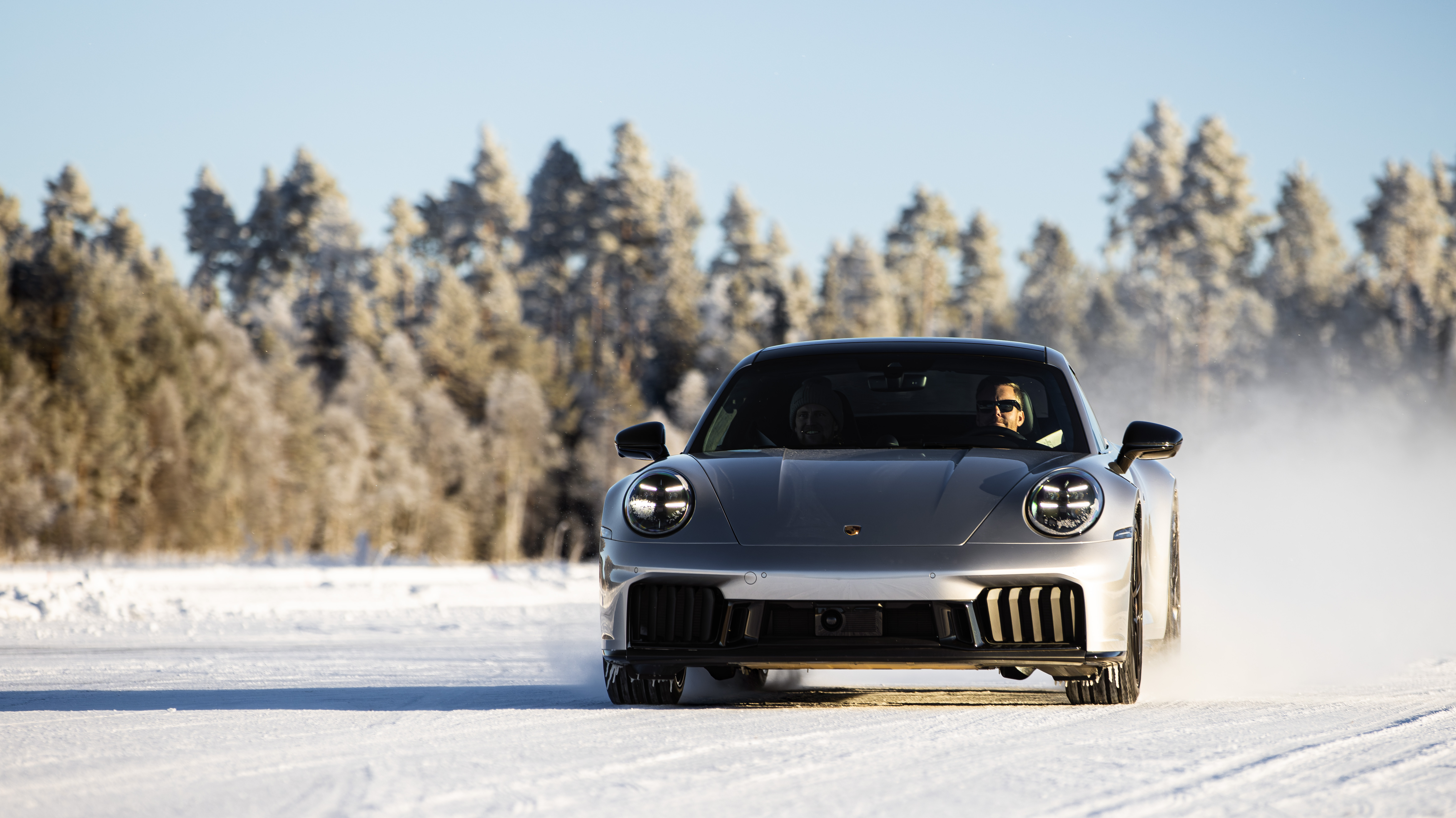A Porsche drifting through snow spray in Östersund, Sweden
