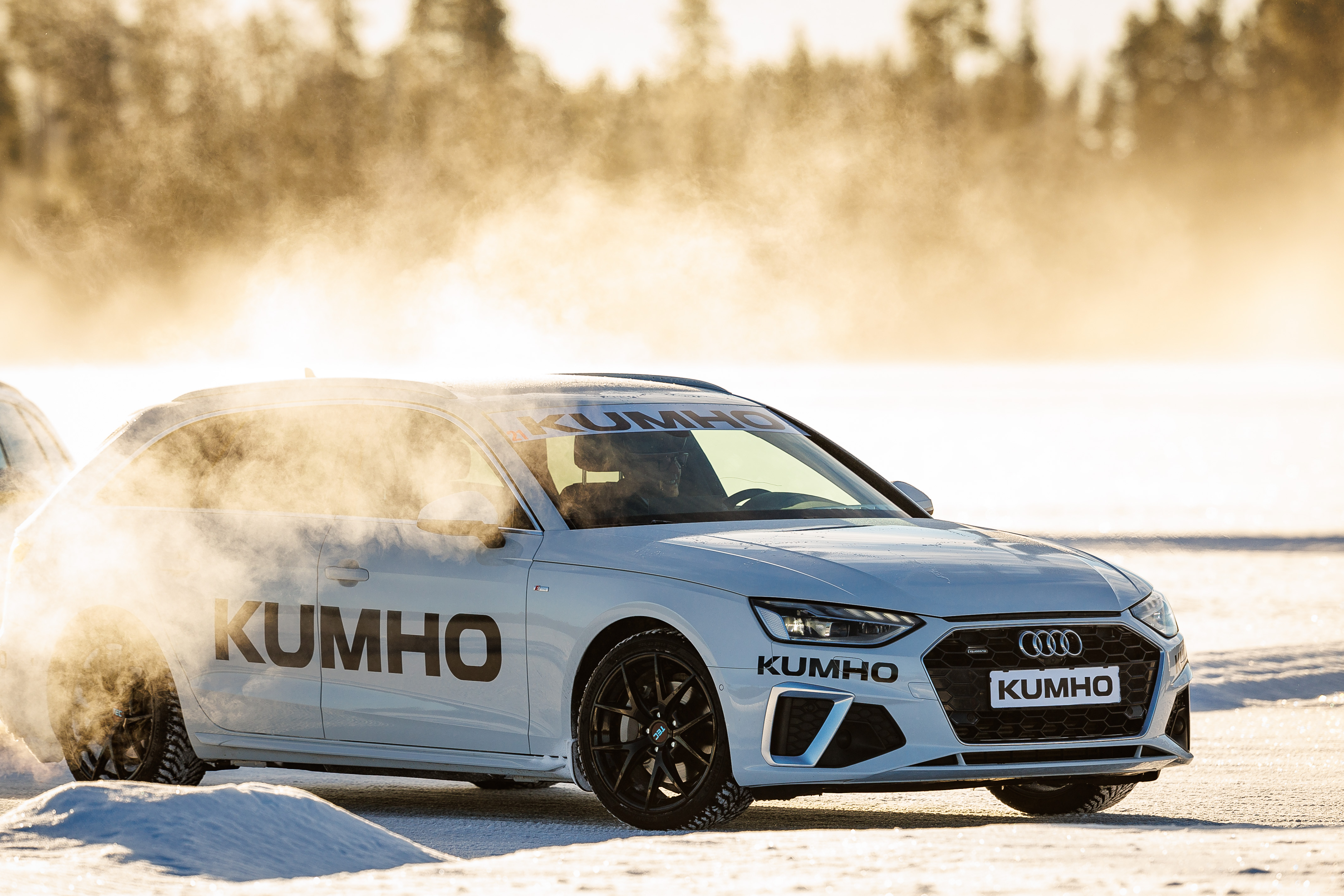 A Kumho tire test car kicking up snow while driving on ice in Östersund, Sweden
