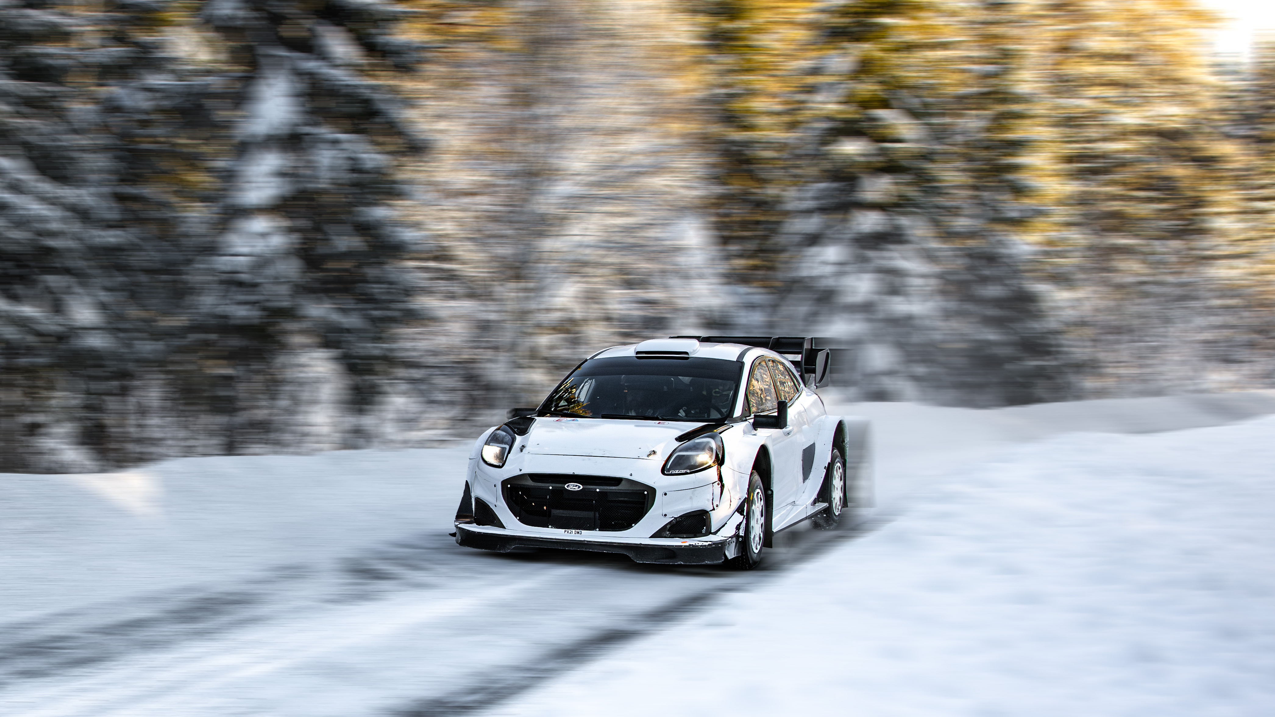 A rally test car drifting on a frozen lake ice track in Jämtland, Sweden
