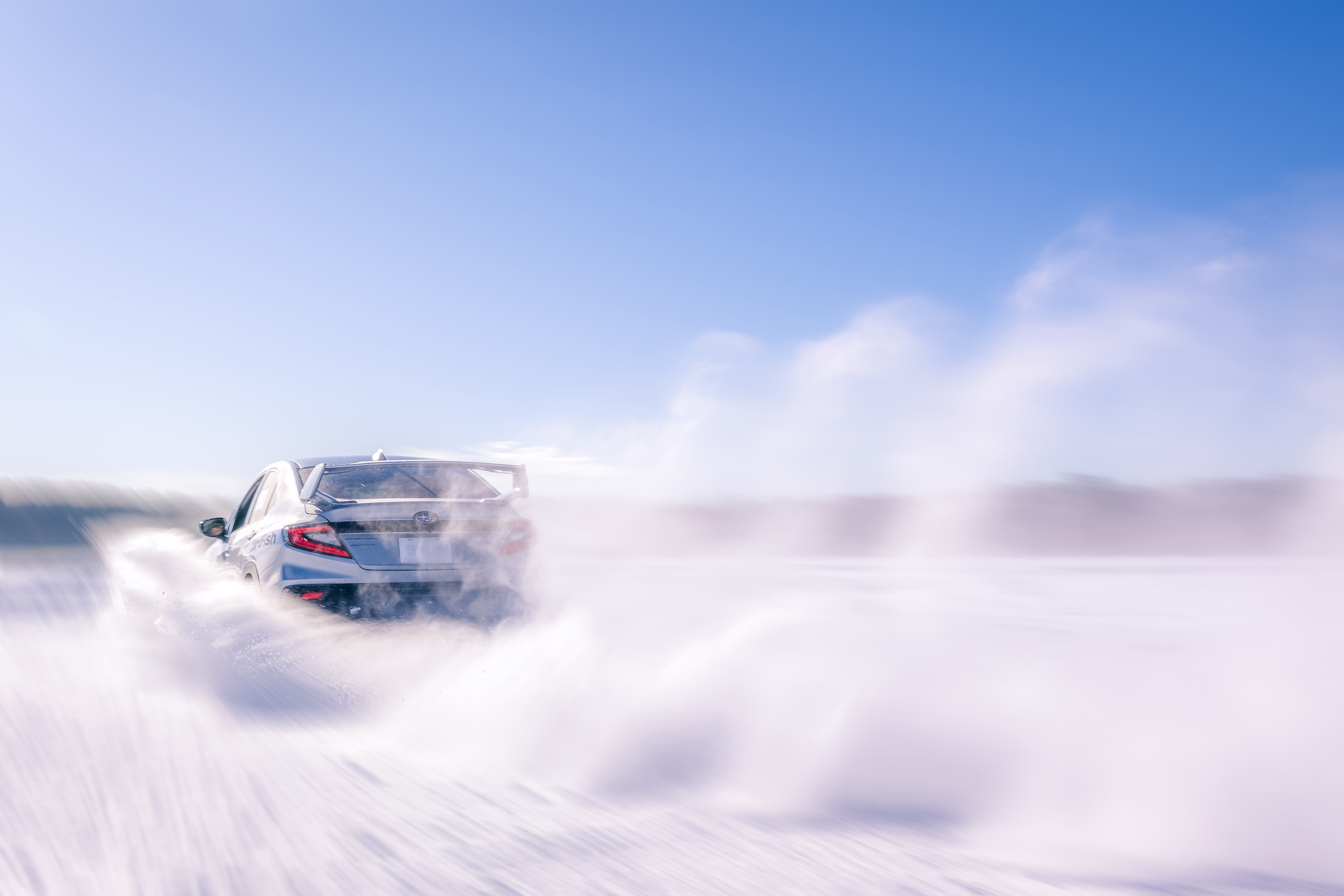 Car drifting on a frozen lake ice track in Sweden