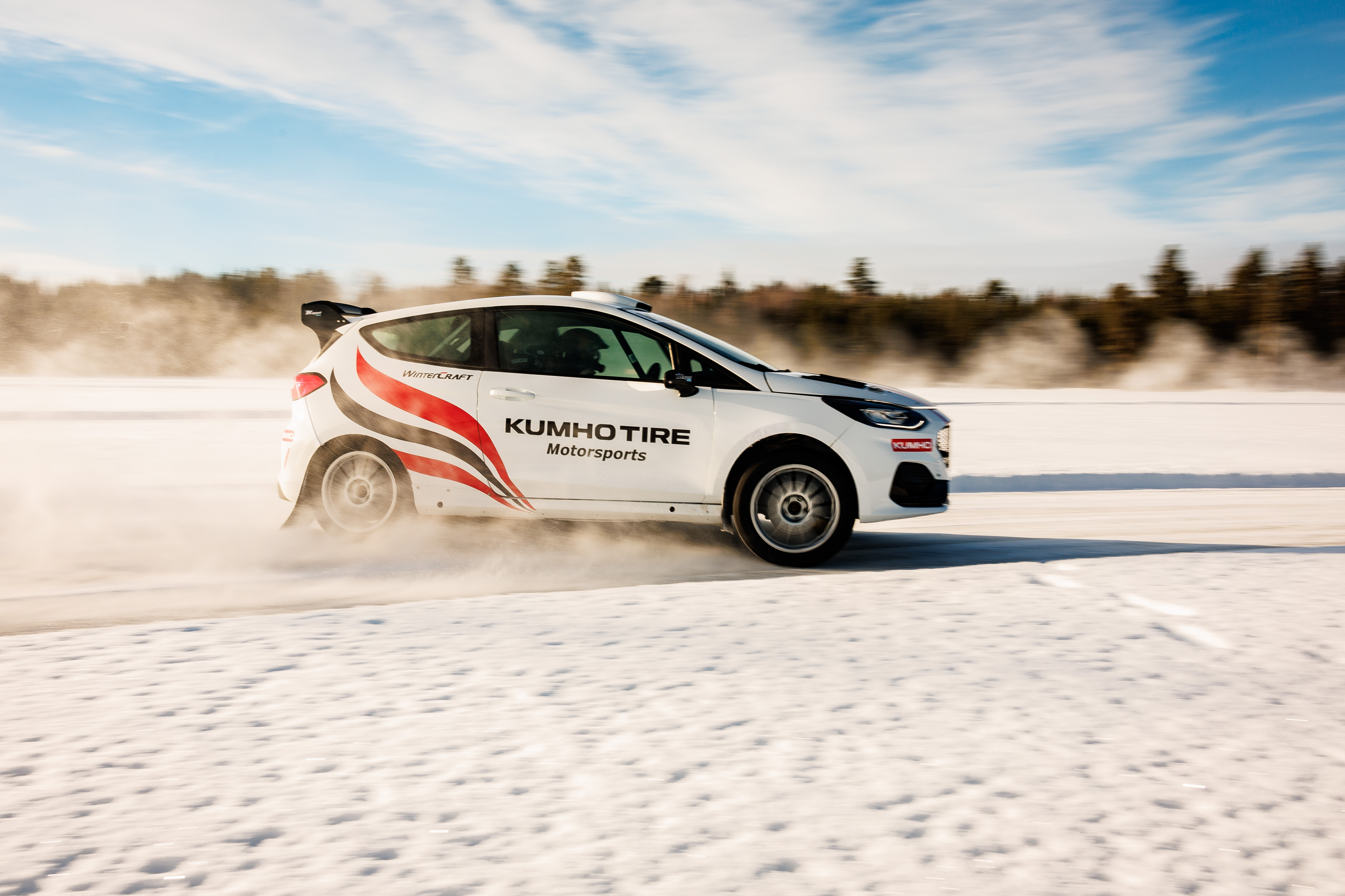 Car driving on a snowy ice track during a corporate event