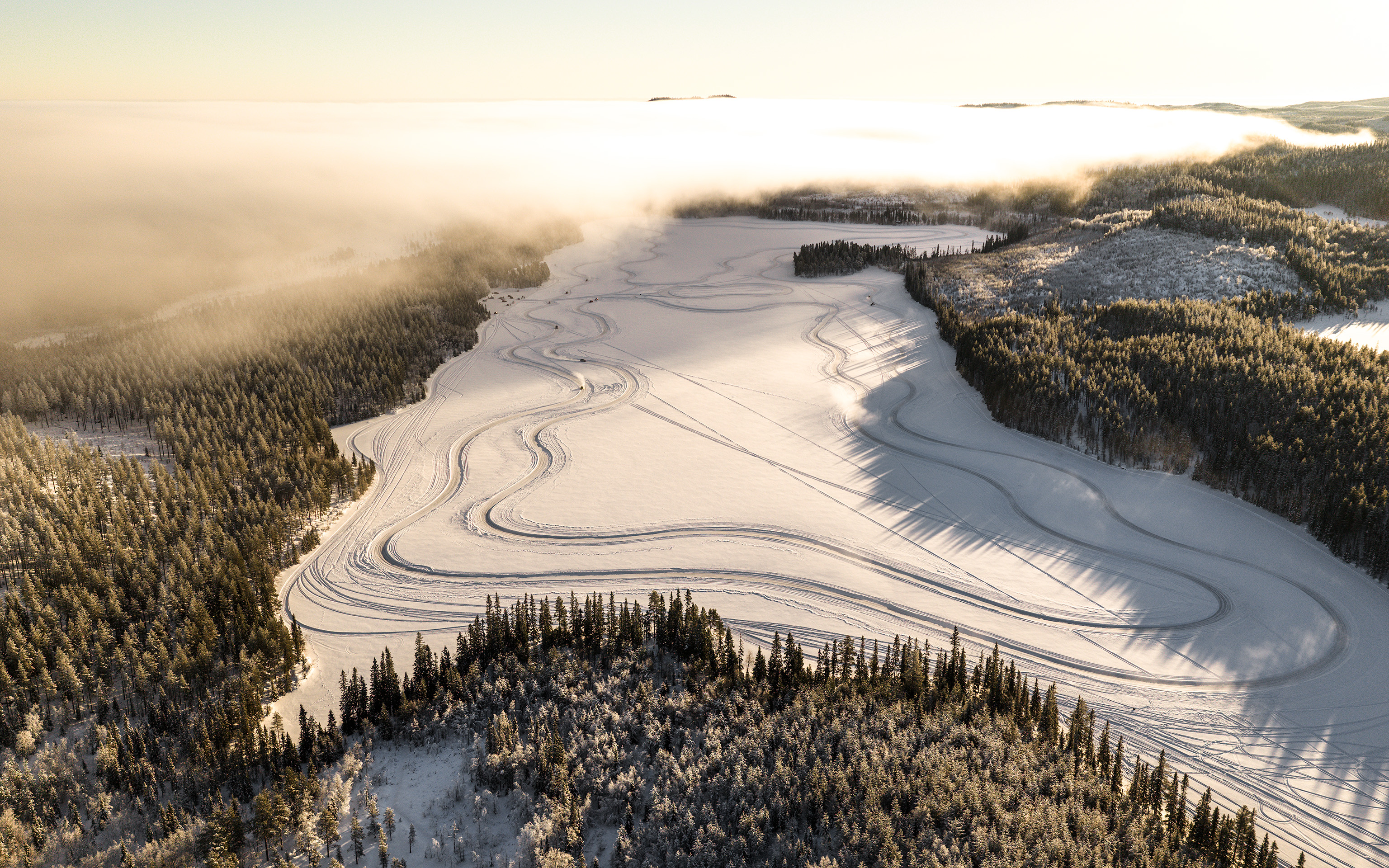 Aerial view of a winding ice track on a frozen lake