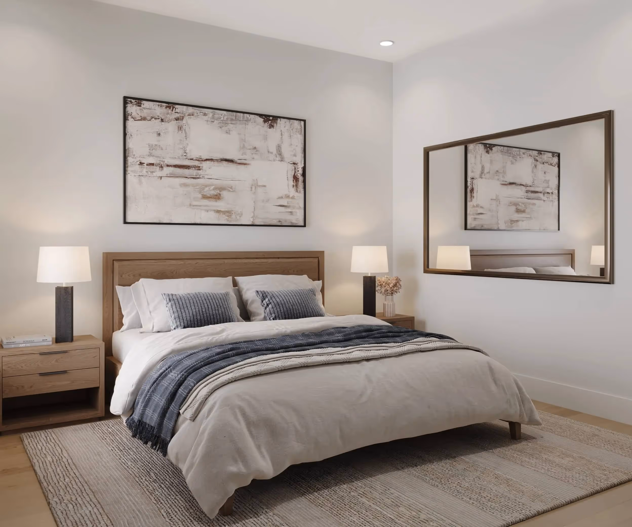 Minimalist bedroom with a wooden bed frame, beige bedding, blue throw blanket, two bedside tables with black lamps, and a large mirror on the wall.