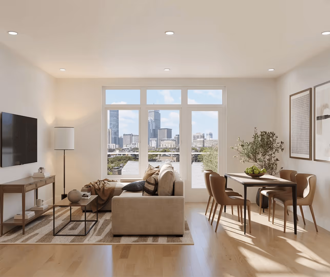 Modern living room with beige sofa, floor lamp, wall-mounted TV, and dining table with four chairs next to large windows overlooking a city skyline.