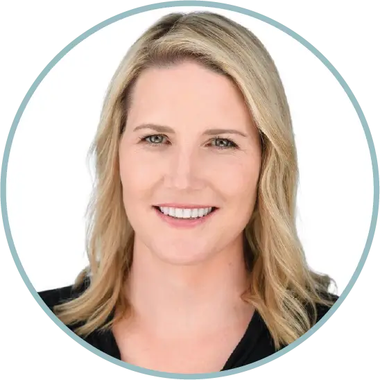 Smiling blonde woman with shoulder-length hair against a white background.