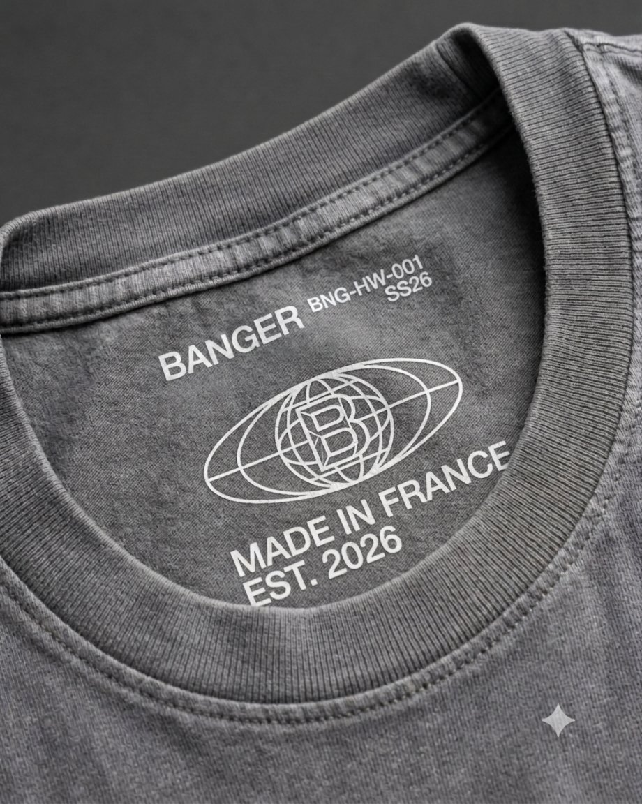Screen-printed tagless neck label on a washed grey heavyweight t-shirt.