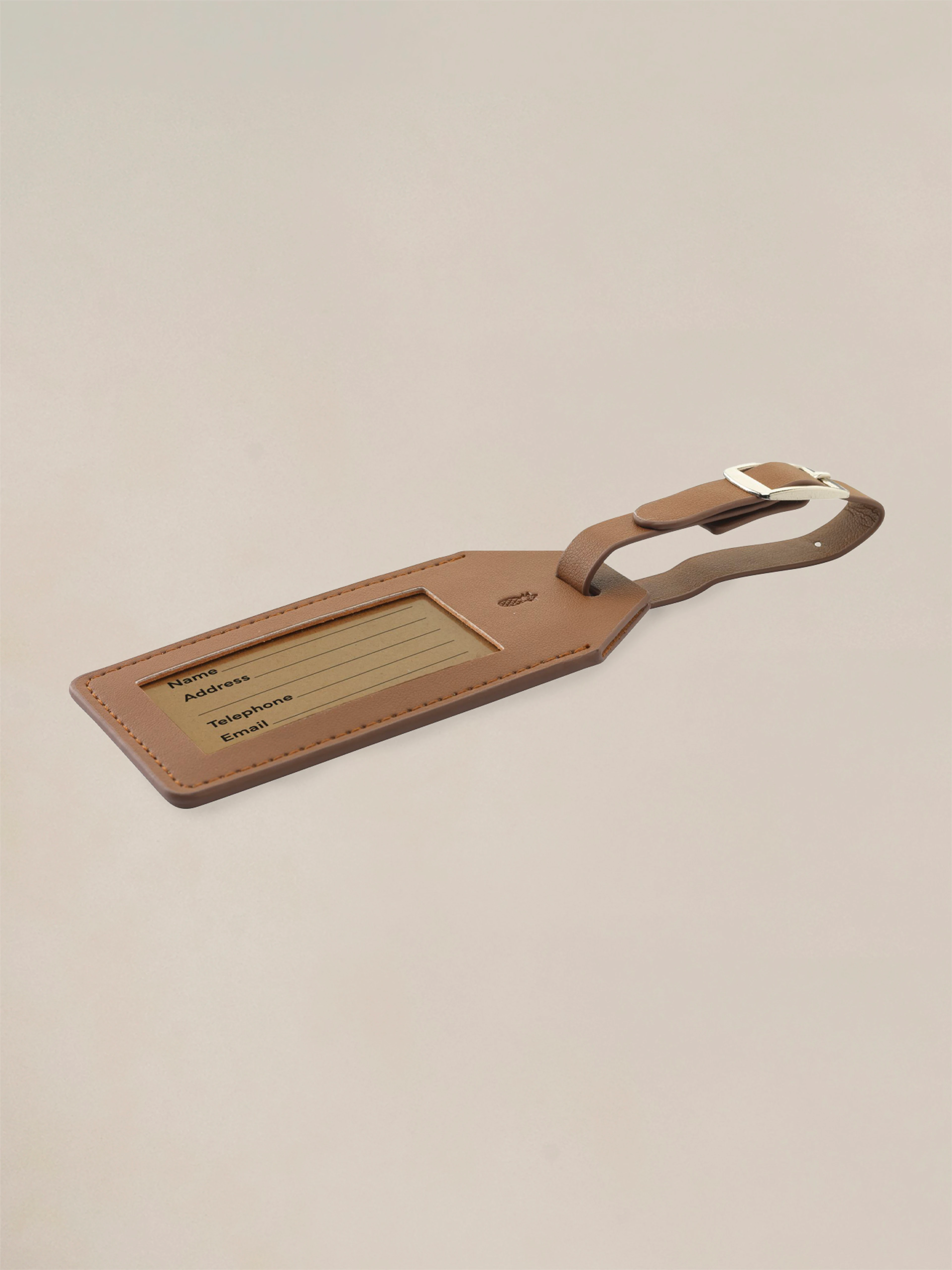 A vegan pineapple leather luggage tag that looks and feels like real leather but is made from pineapple leaves, designed for modern travelers.
