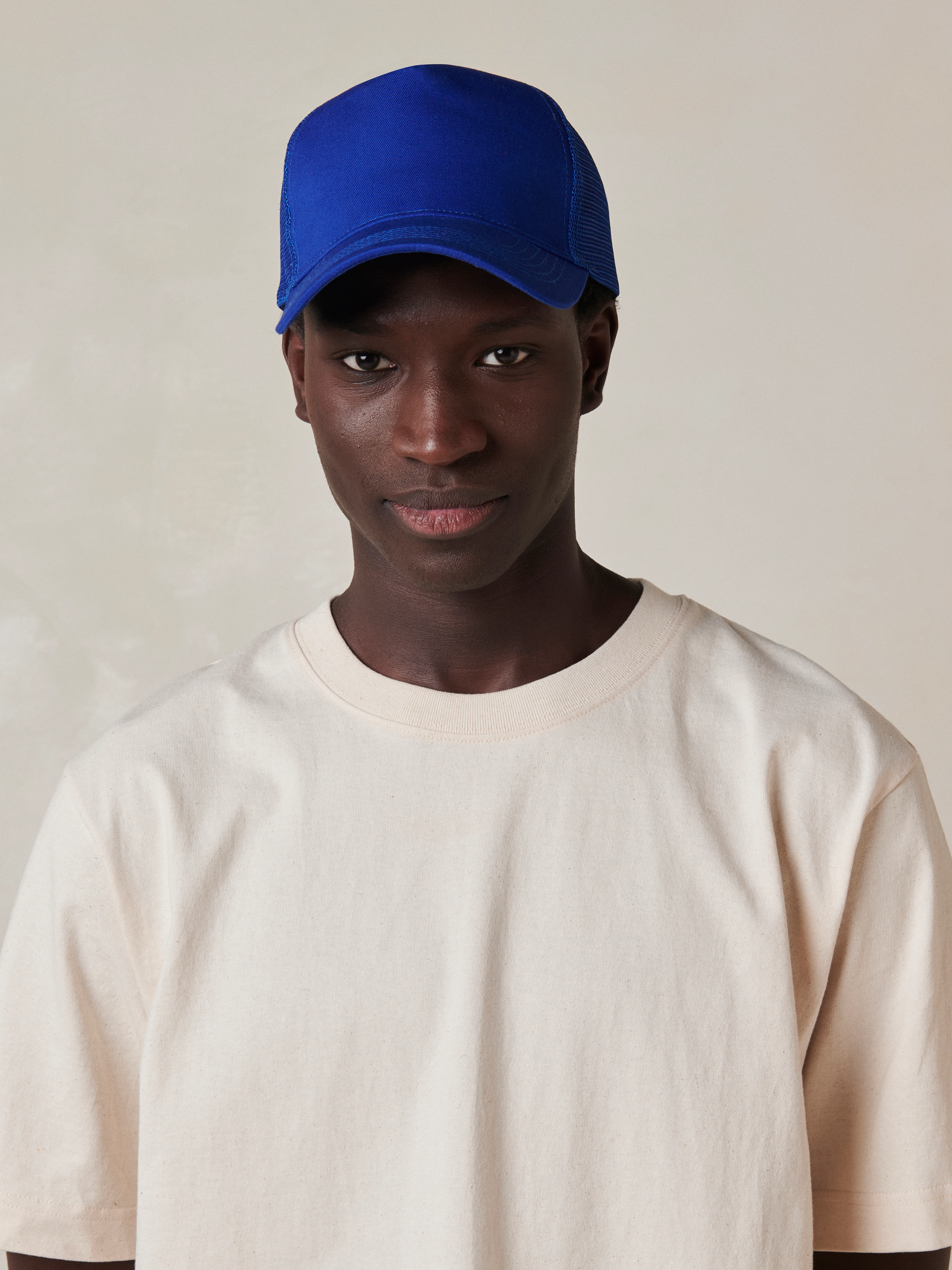 A modern take on the classic trucker cap, featuring a structured cotton front, breathable mesh back, and a clean curved visor for everyday wear.