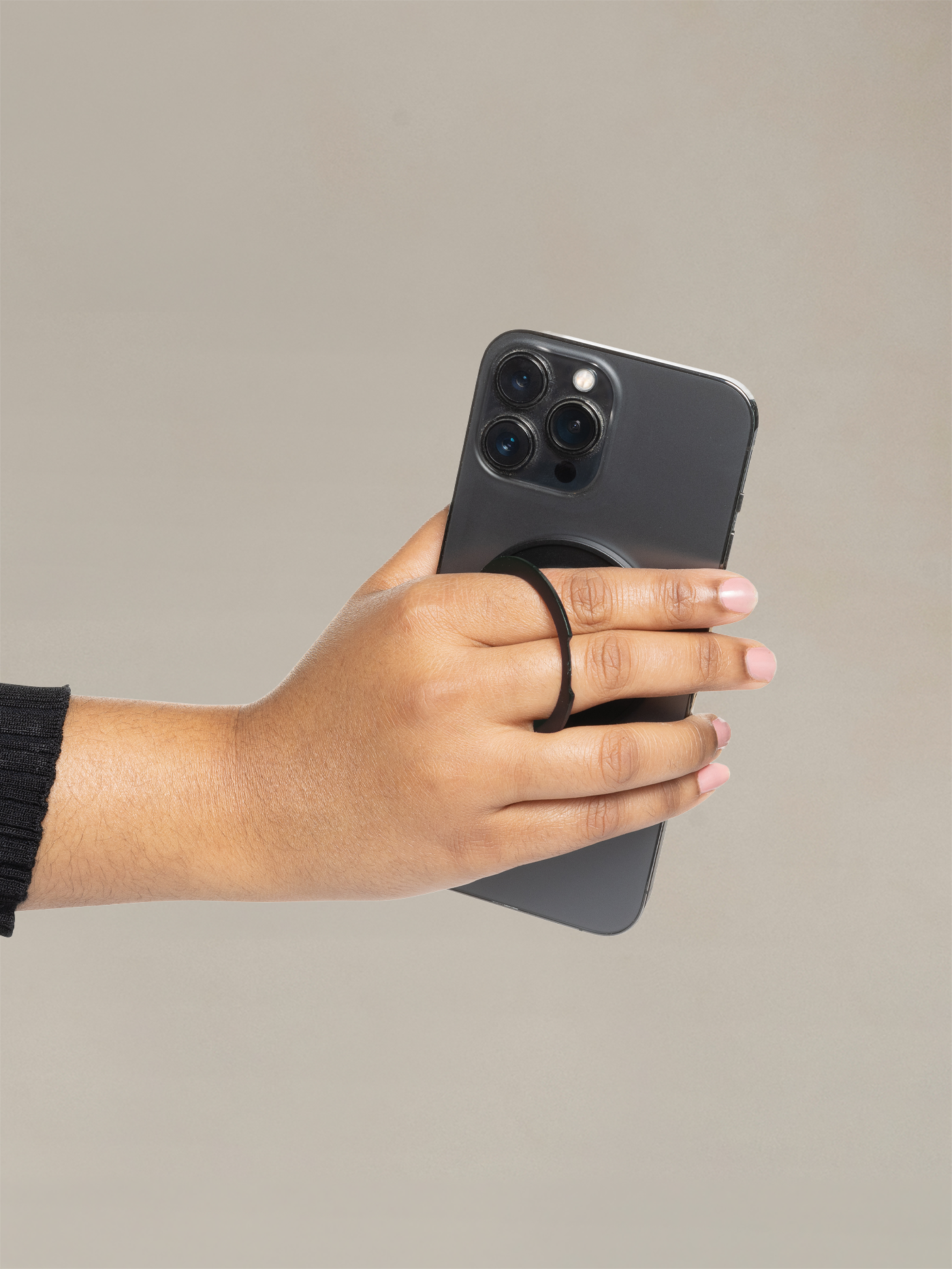 Magnetic phone holder with a foldable ring for hands-free viewing or a secure grip.