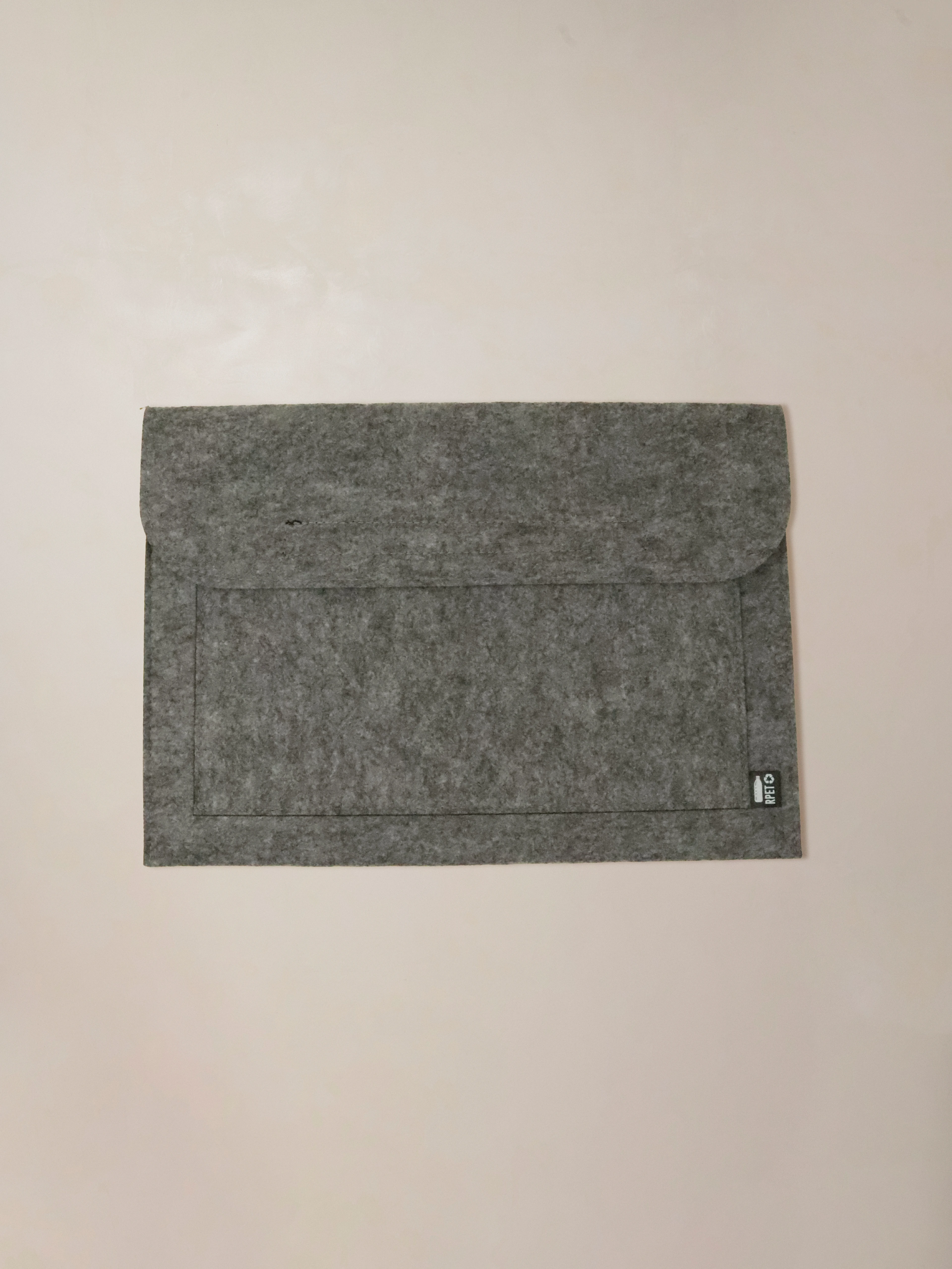 A recycled laptop sleeve that combines everyday functionality with eco-conscious design.