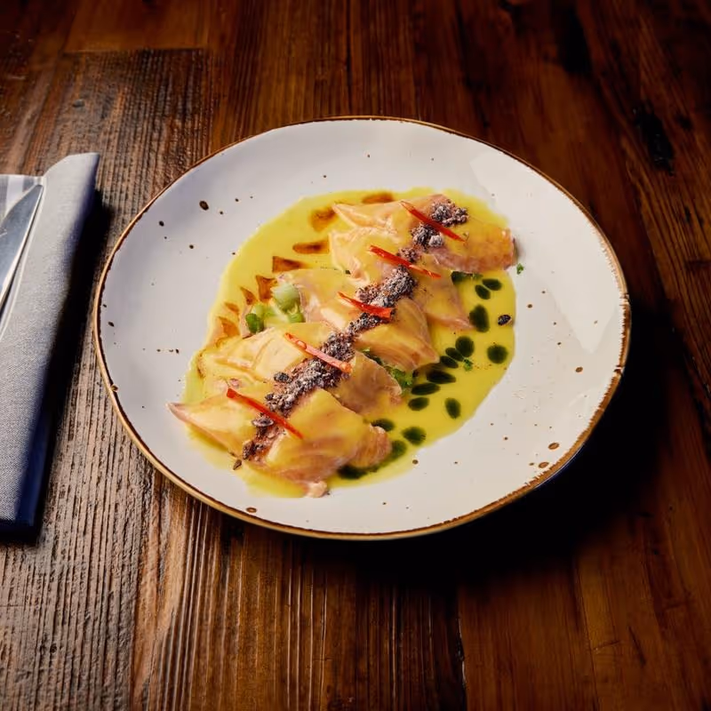 Salmon sashimi ceviche, passion fruit citrus, micro cilantro, purple corn, onion, aji amarillo