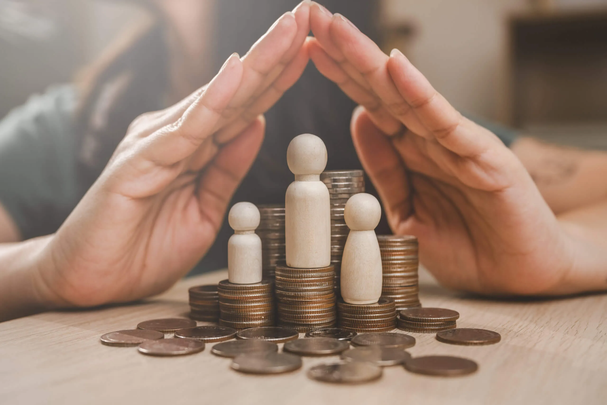 Hands over some coins and human figures