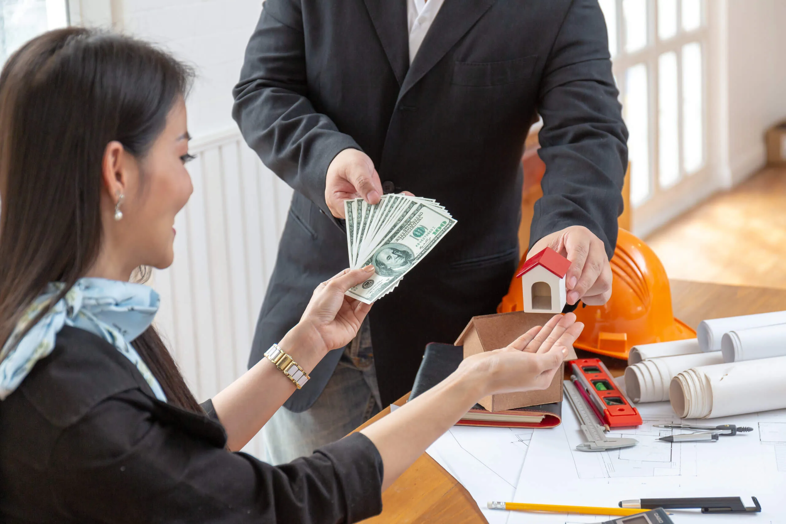 Client giving money getting a house model