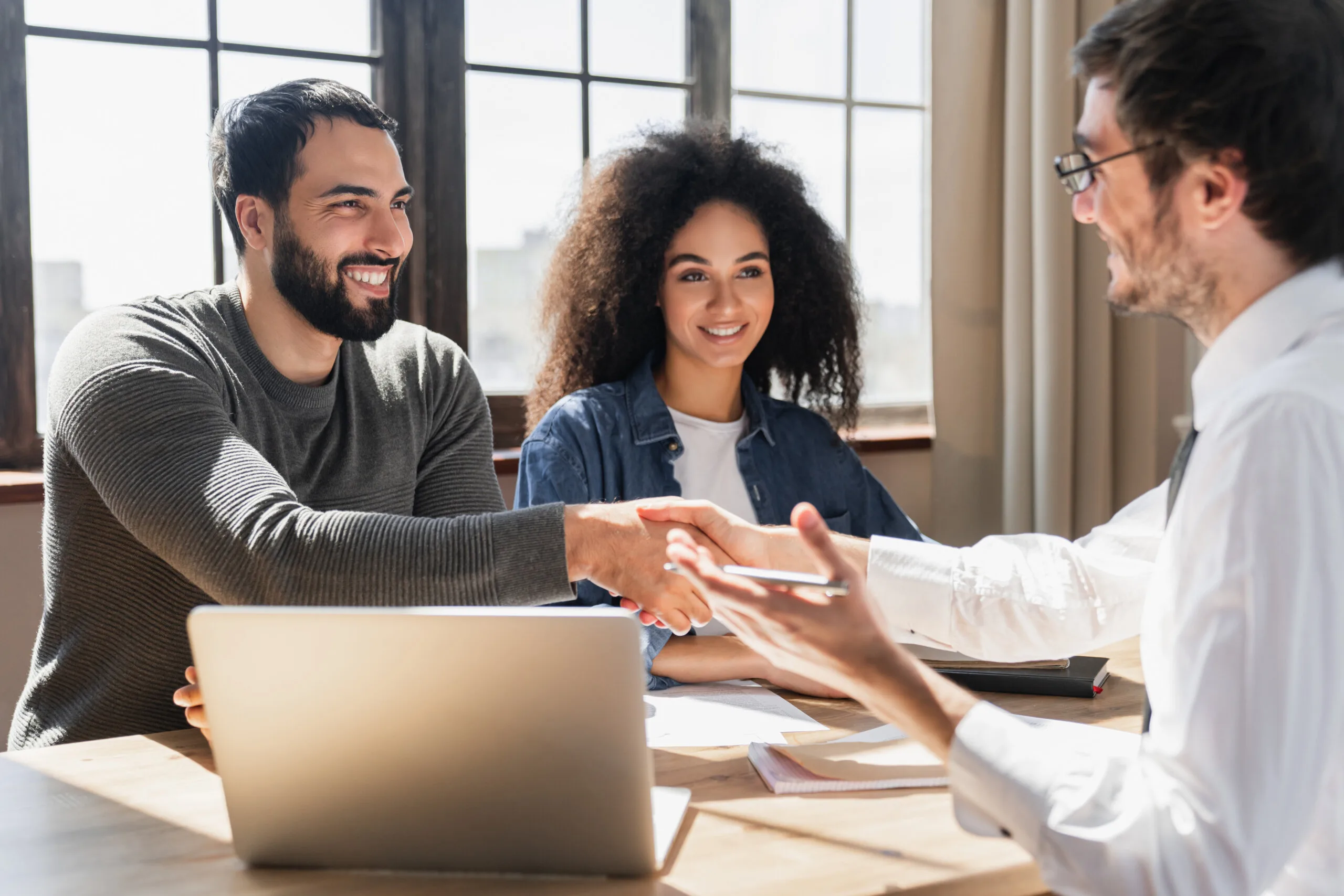 Loan officer offering lender solutions to a young couple