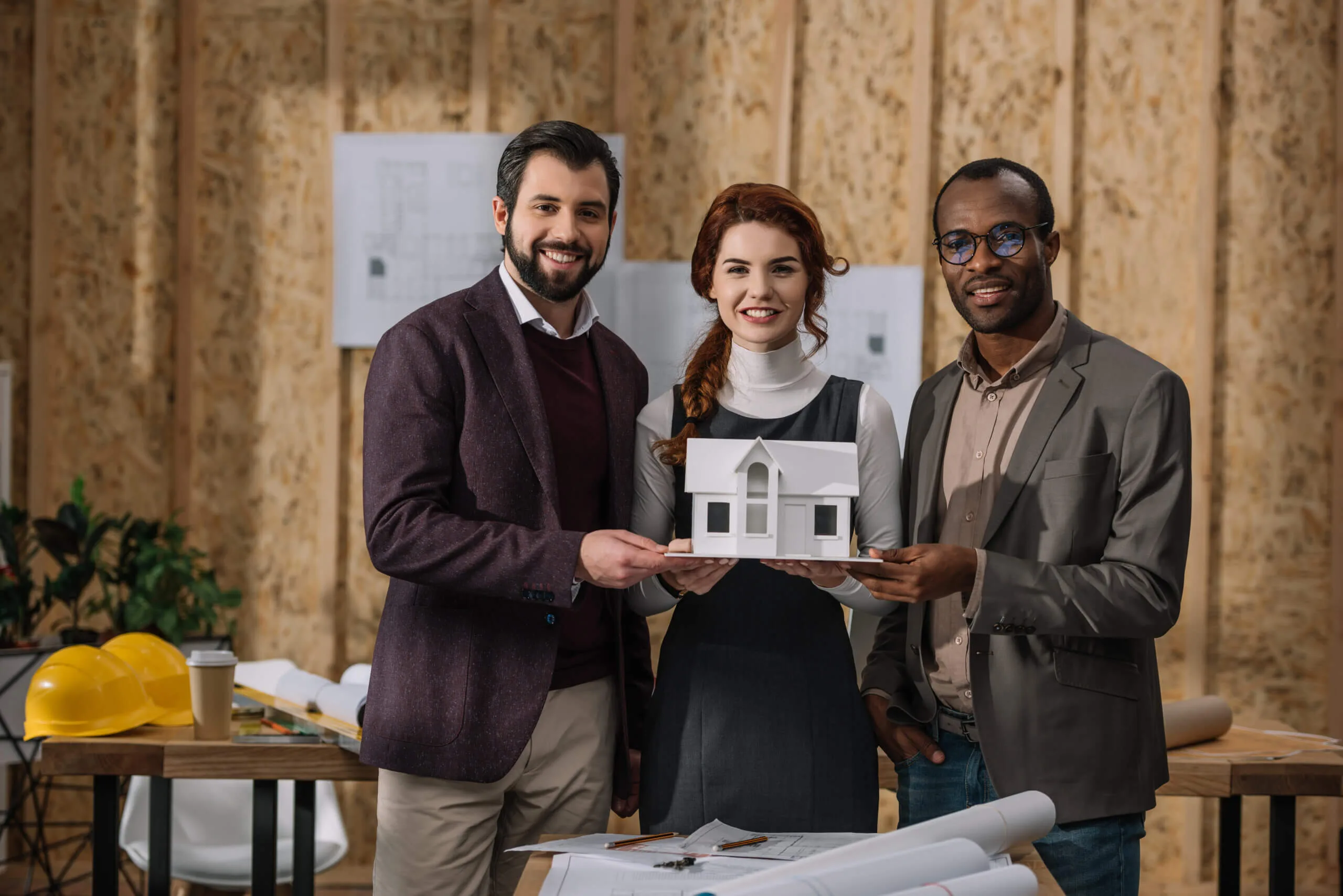 Constructors holdng a house model