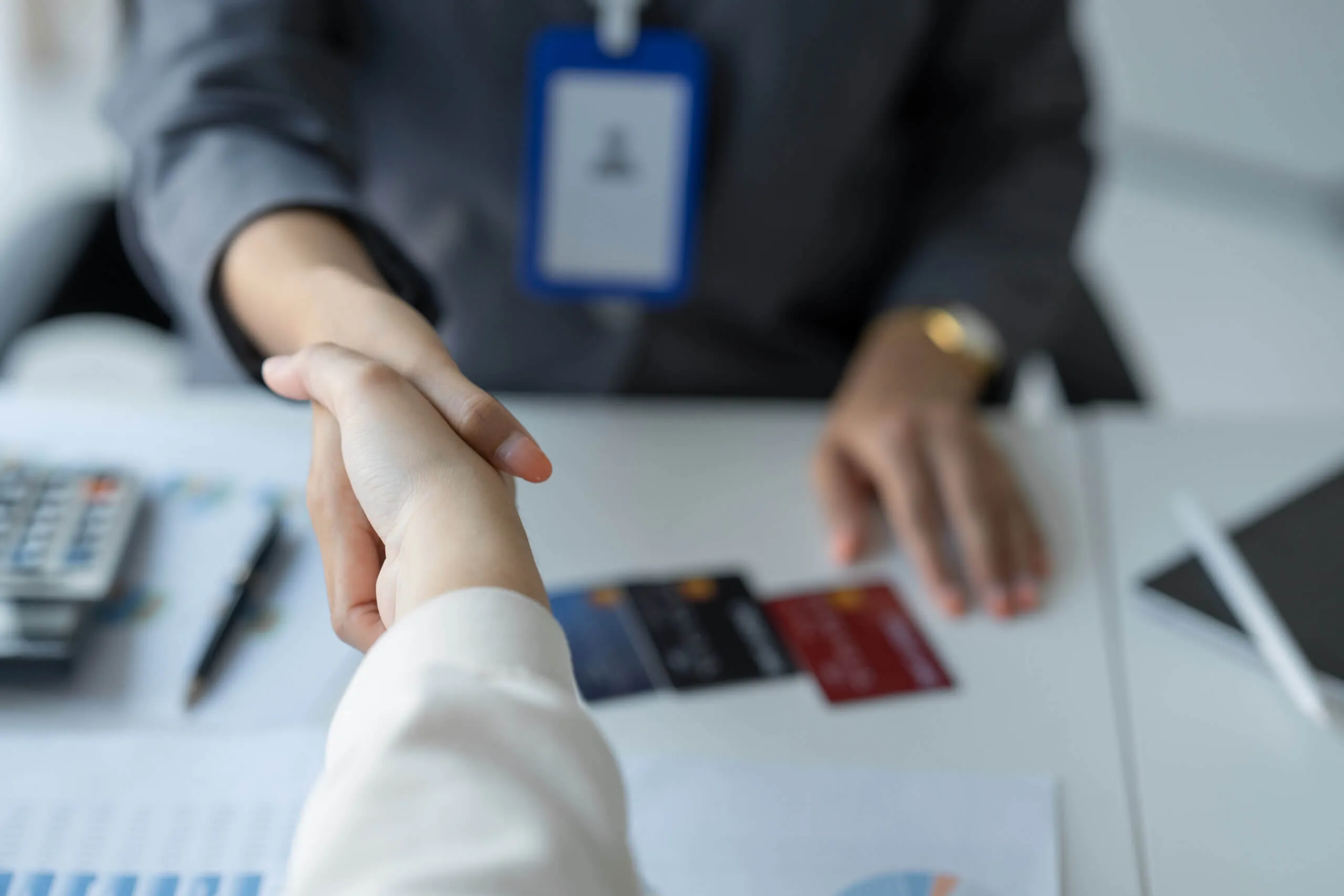 Two people shakng hands over non-contingent financing