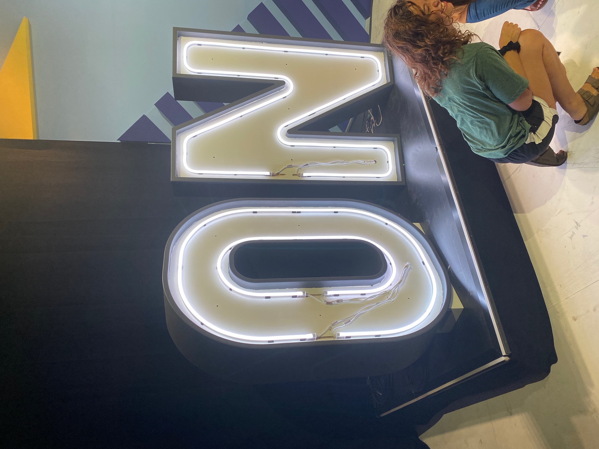We designed the CNC files for the face of this sign, custom manufactured retaining clips for the flexible neon product and provided the LED product and driver scenario for this project.  Yes, the gaps and exposed cable were part of the artwork supplied by the client.