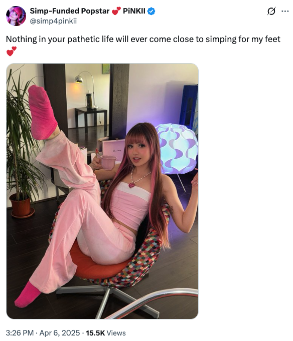 A young woman in a pink sweatsuit and hot pink socks looks at the camera and sips tea while raising one foot toward the camera. The caption reads "Nothing in your pathetic life will ever come close to simping for my feet." It's posted by the musician PiNKII on twitter