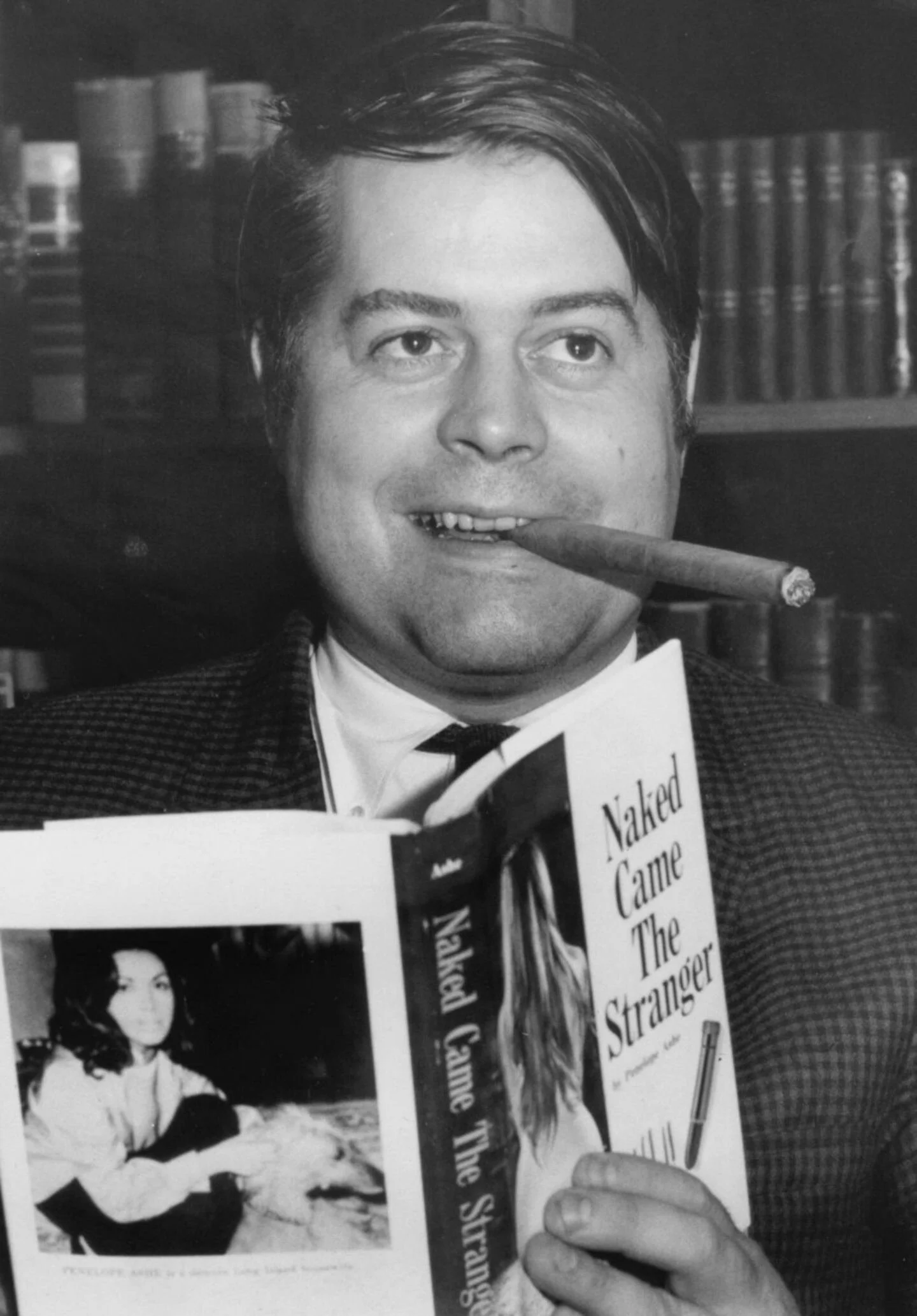 Journalist Mike McGrady, co–author of Ordeal (1980), posing with the sexually explicit hoax book that he masterminded a decade earlier
