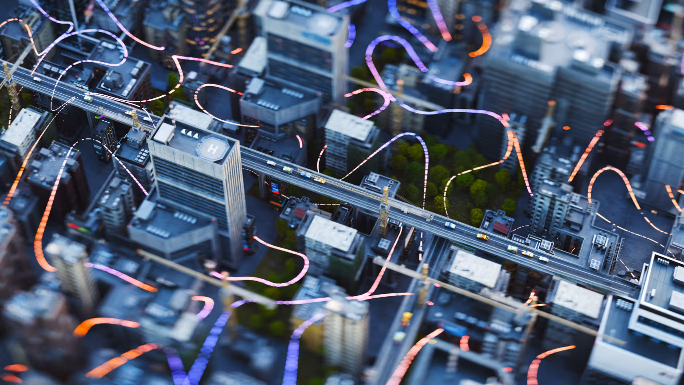 Aerial view of a cityscape with a highway passing through tall buildings and colorful light trails overlay.