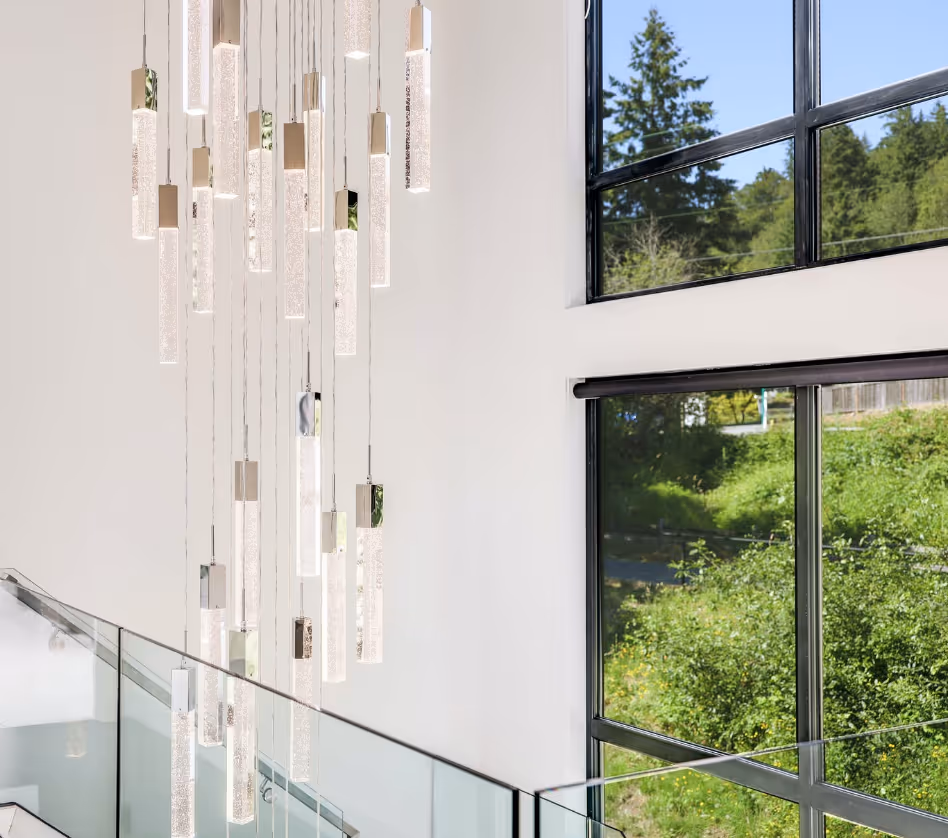 Rear view of a man wearing a yellow hard hat and a blue t-shirt with the logo and text 'Draper Construction' on the back.