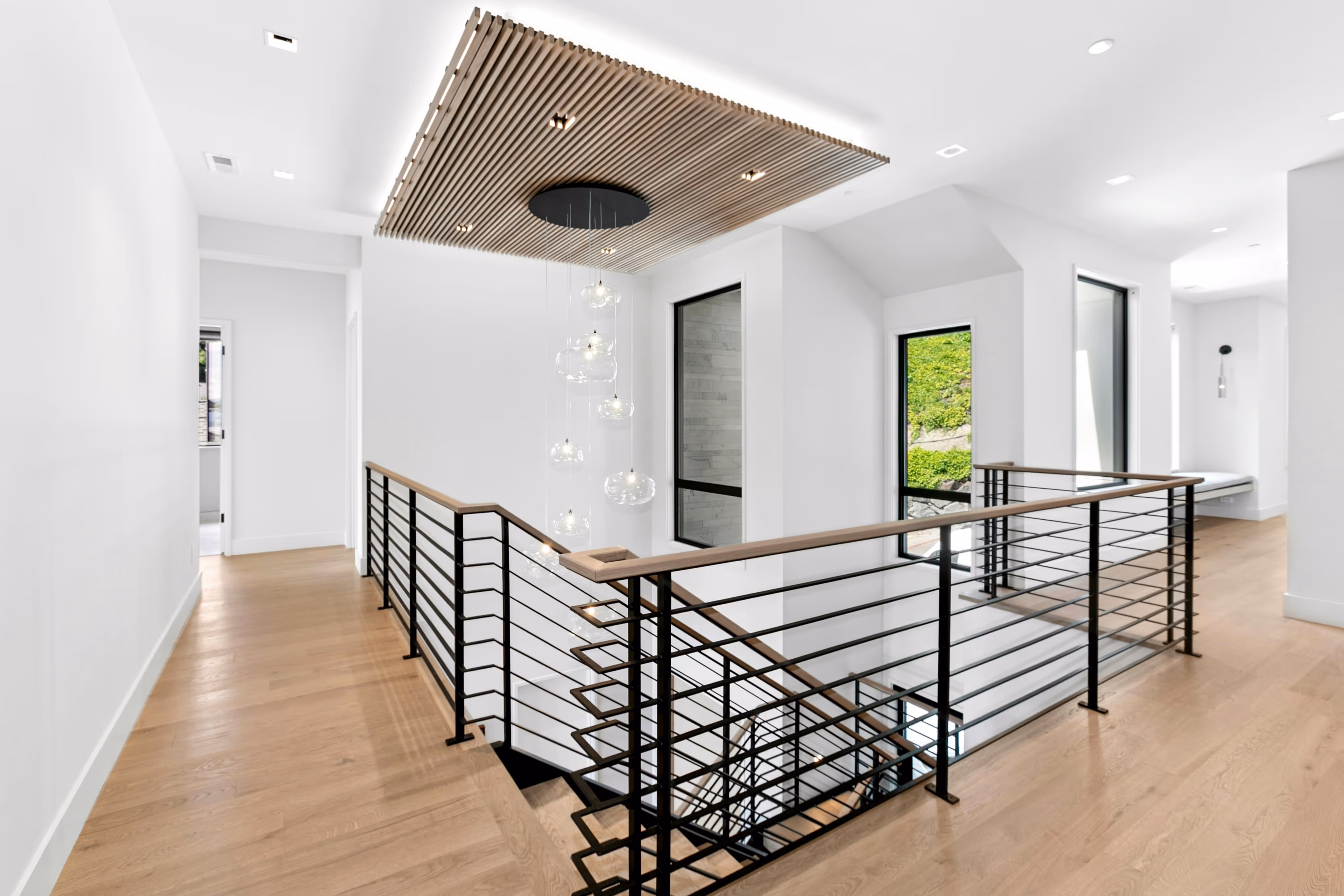 Rear view of a man wearing a yellow hard hat and a blue t-shirt with the logo and text 'Draper Construction' on the back.
