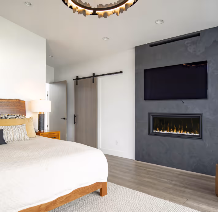 Rear view of a man wearing a yellow hard hat and a blue t-shirt with the logo and text 'Draper Construction' on the back.