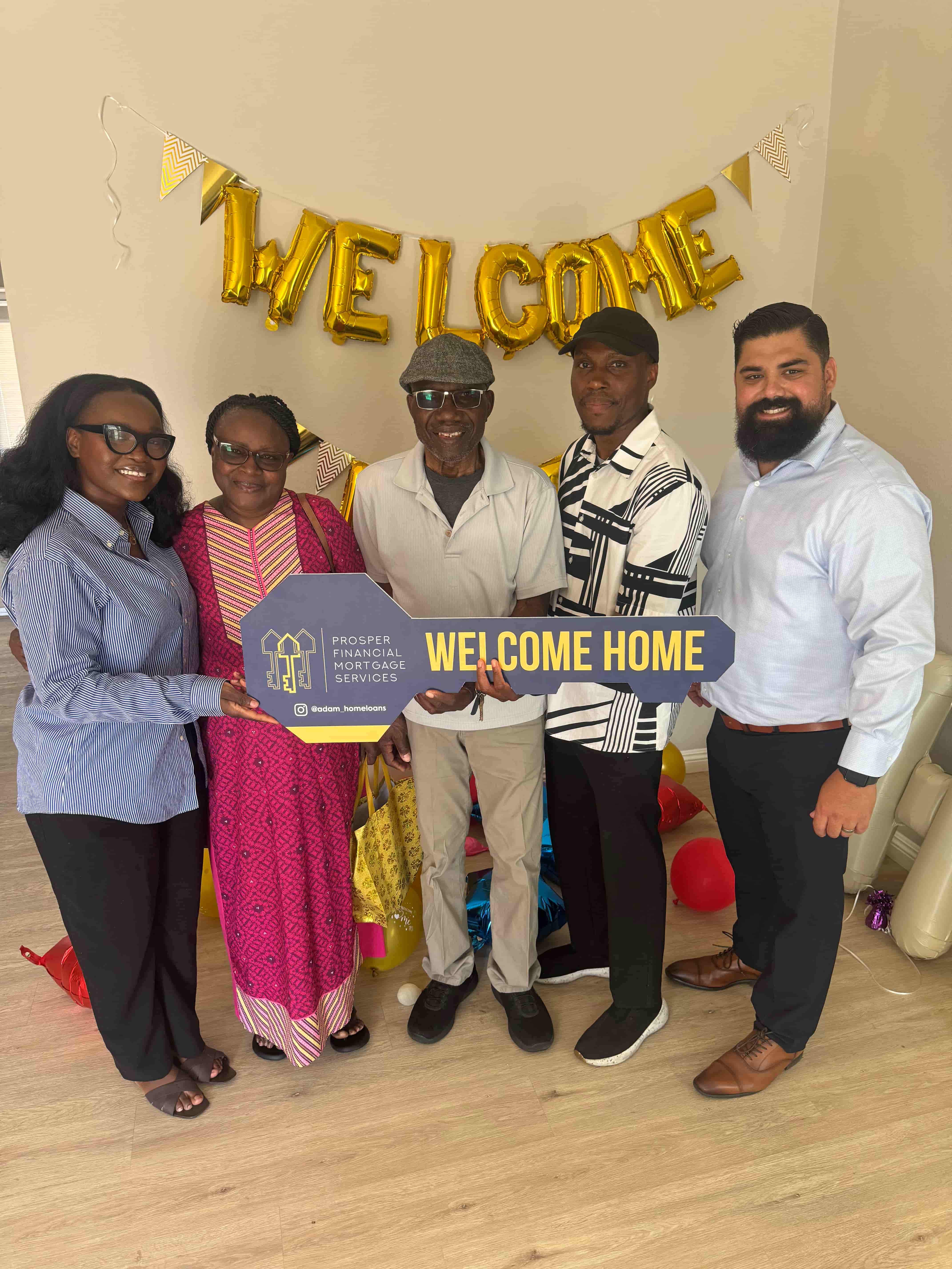 Two people indoors holding and swinging bright pink foam batons playfully on a wood floor with white walls and exposed wooden ceiling beam.