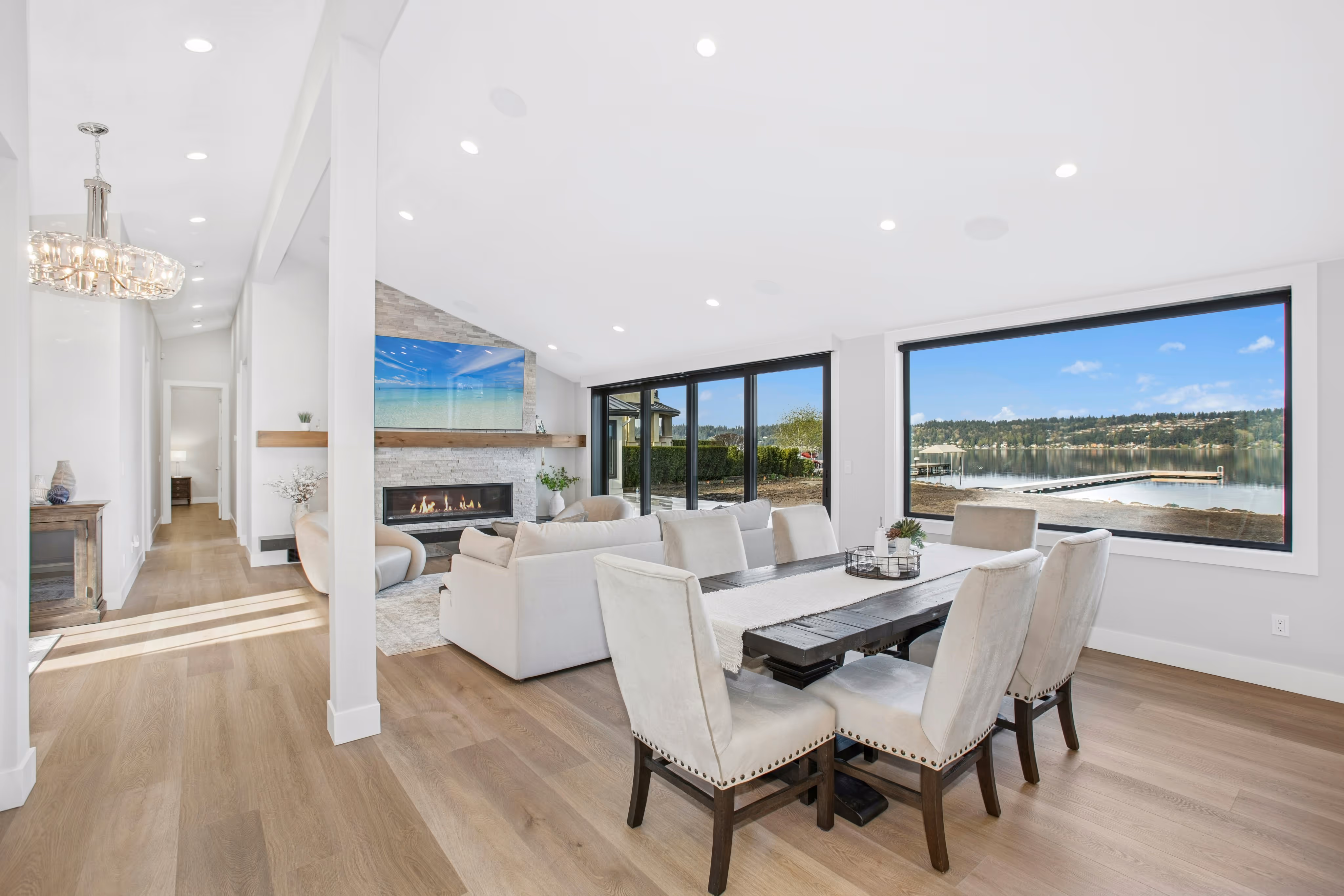 Modern bathroom vanity with light wood drawers, white marble countertop, round mirror, and brass faucet.