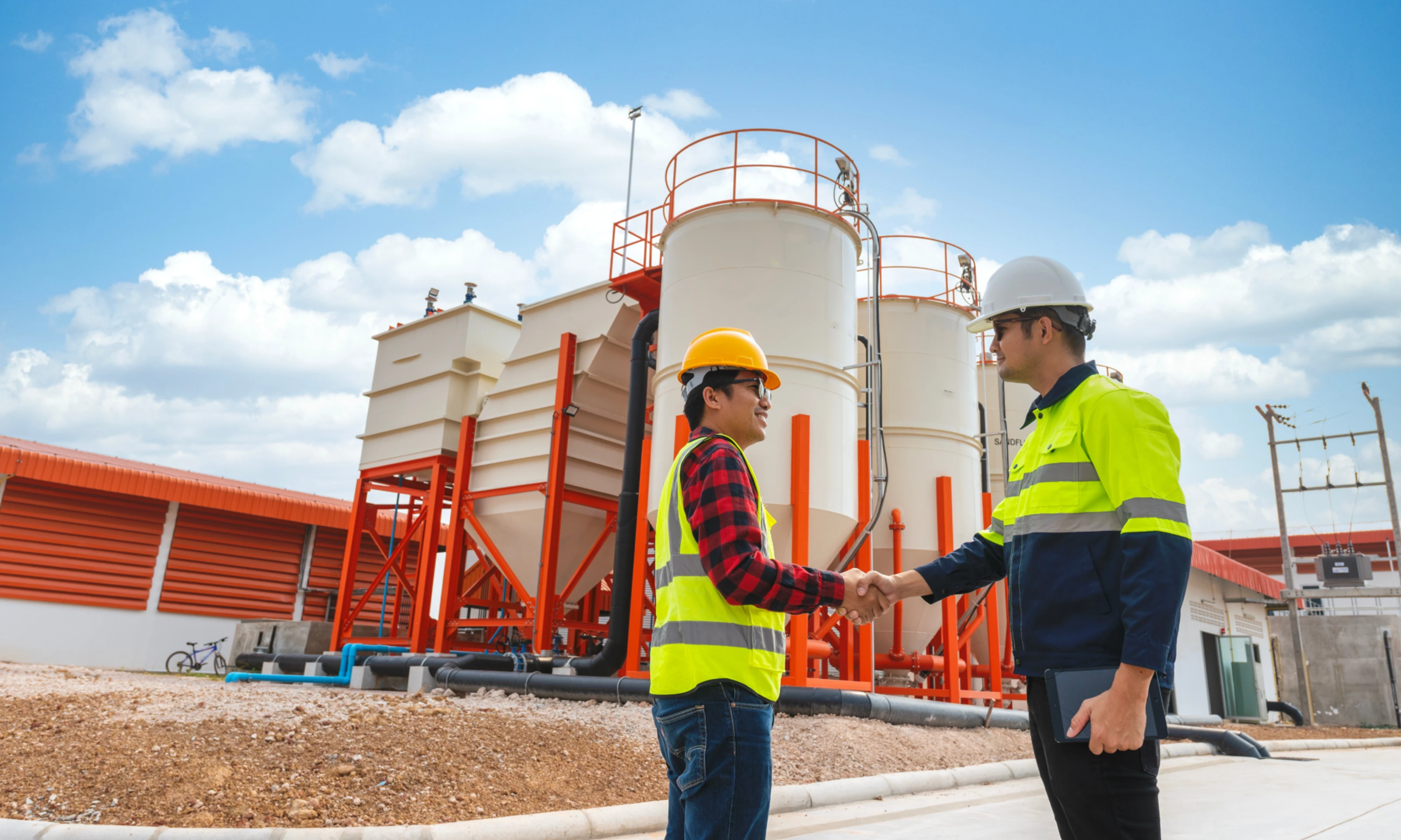 Two construction workers shaking hands at construction site