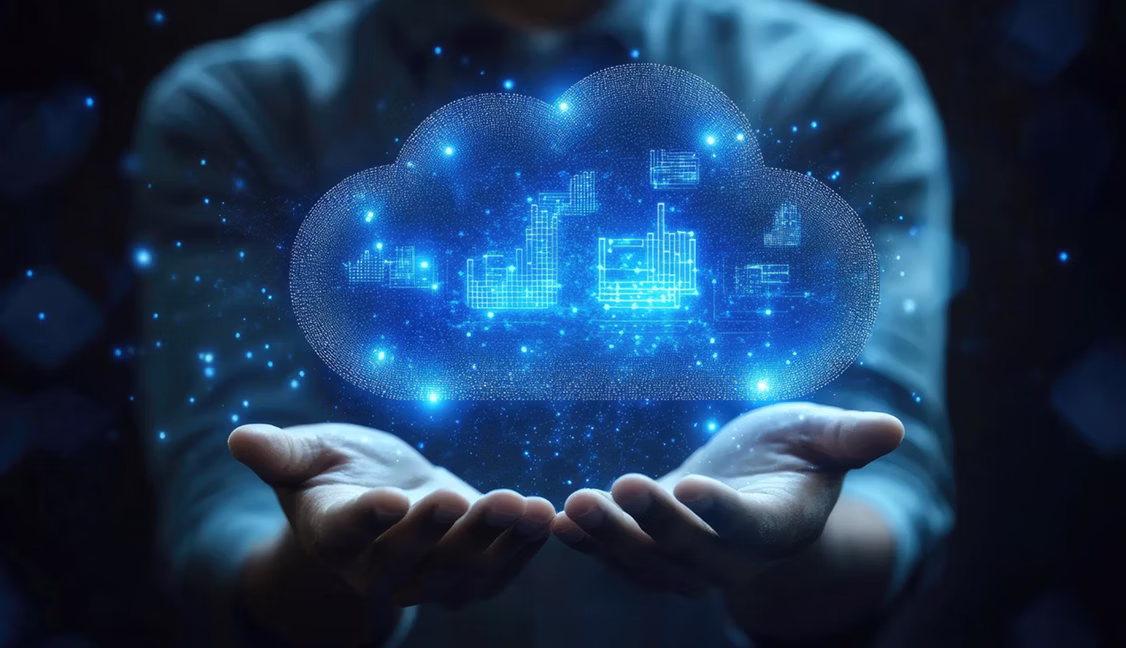 Person holding a glowing digital cloud with data nodes and network connections representing cloud computing.