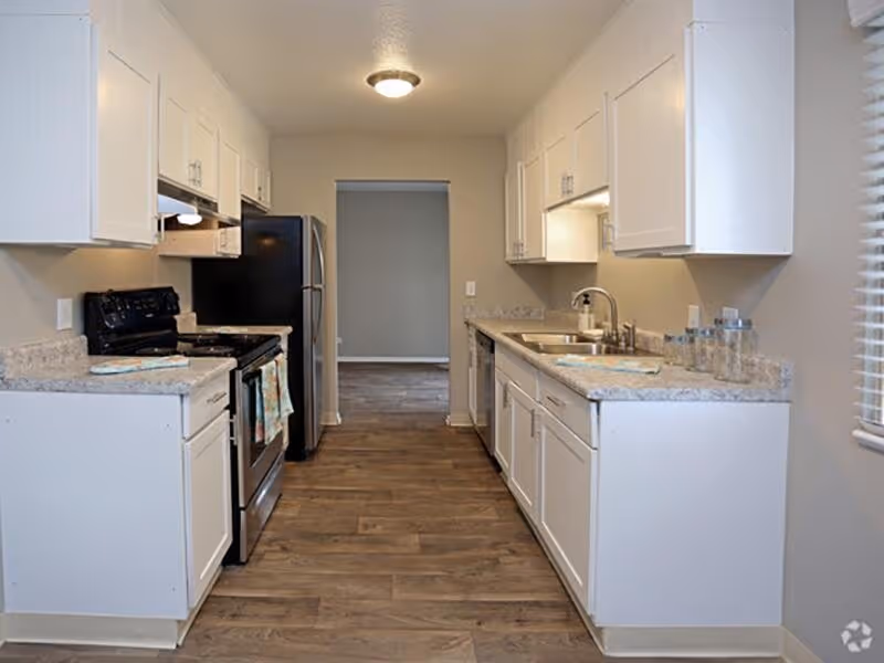 Kitchen with white cabinets and black appliances
