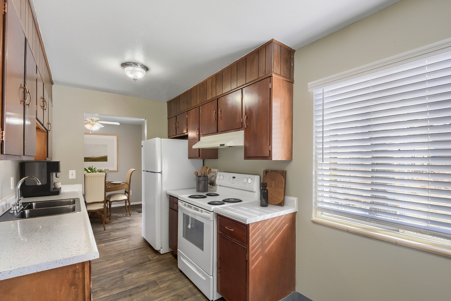 Kitchen with white cabinets and black appliances