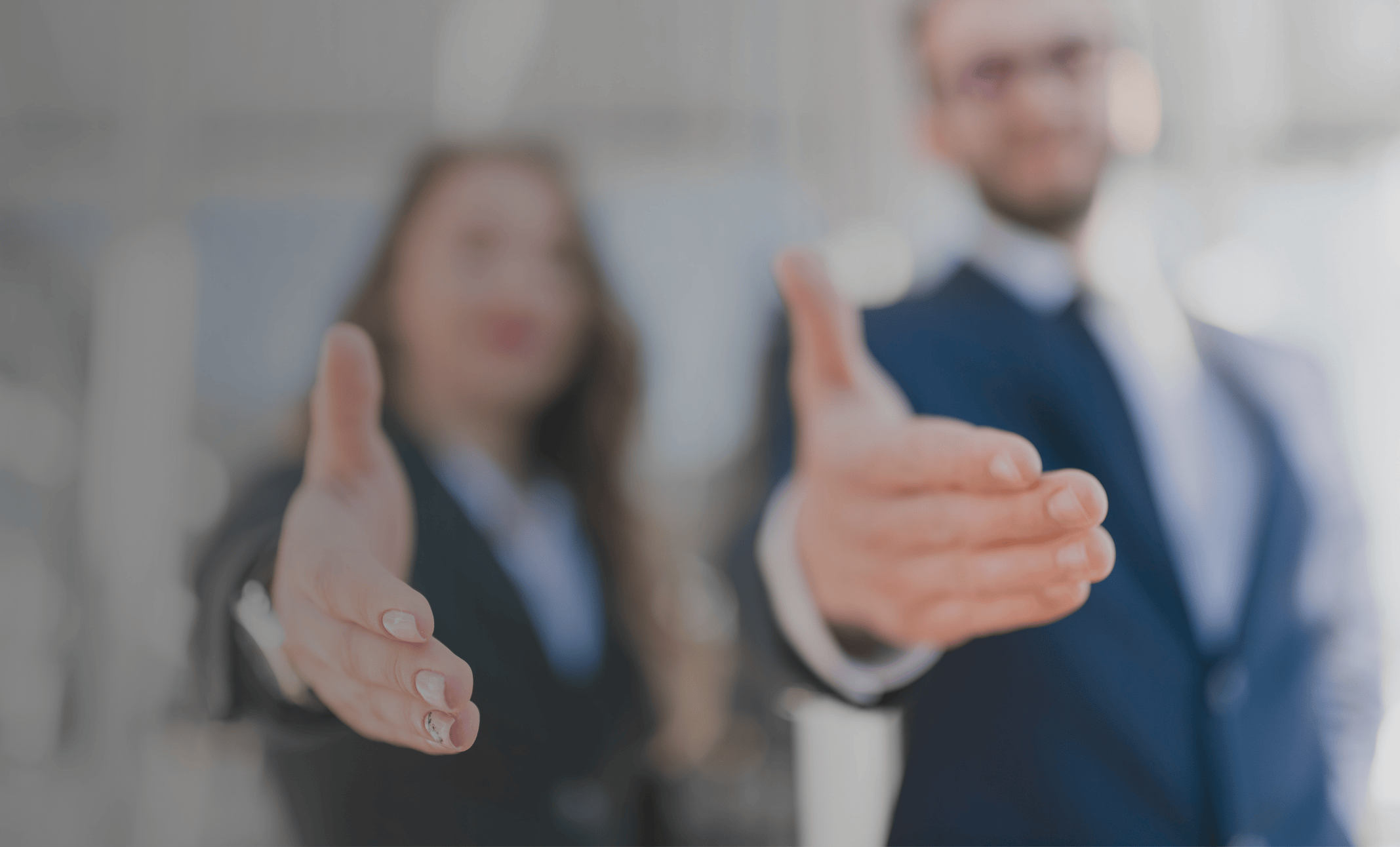 Two cybersecurity professionals extending their hands to potential clients. Representative of the fact that a human focused cybersecurity partnership begins with TPG Consulting.