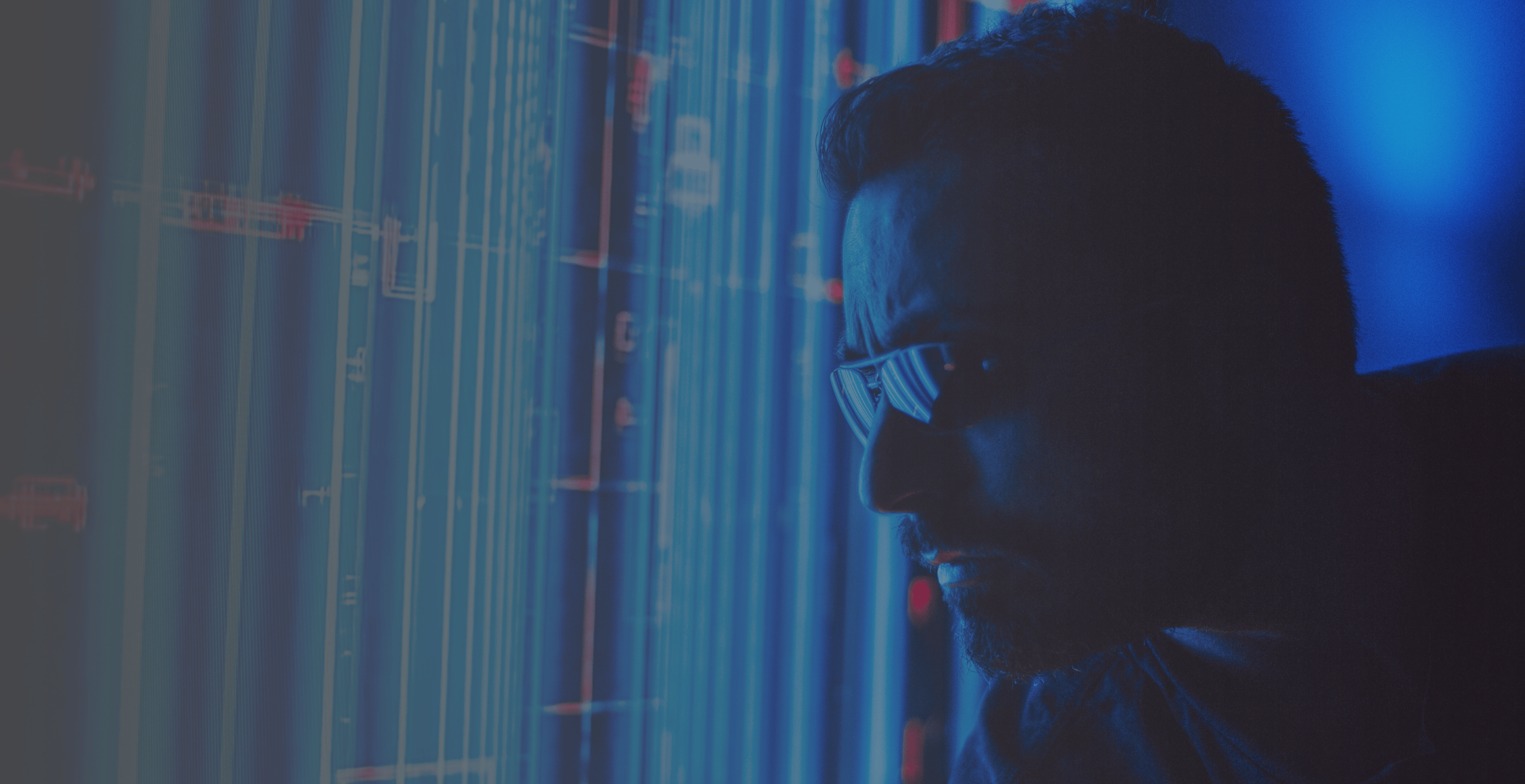 A futuristic image of a male cybersecurity professional reviewing a hologram of streaming security data. Representative of a TPG Consulting consultant.