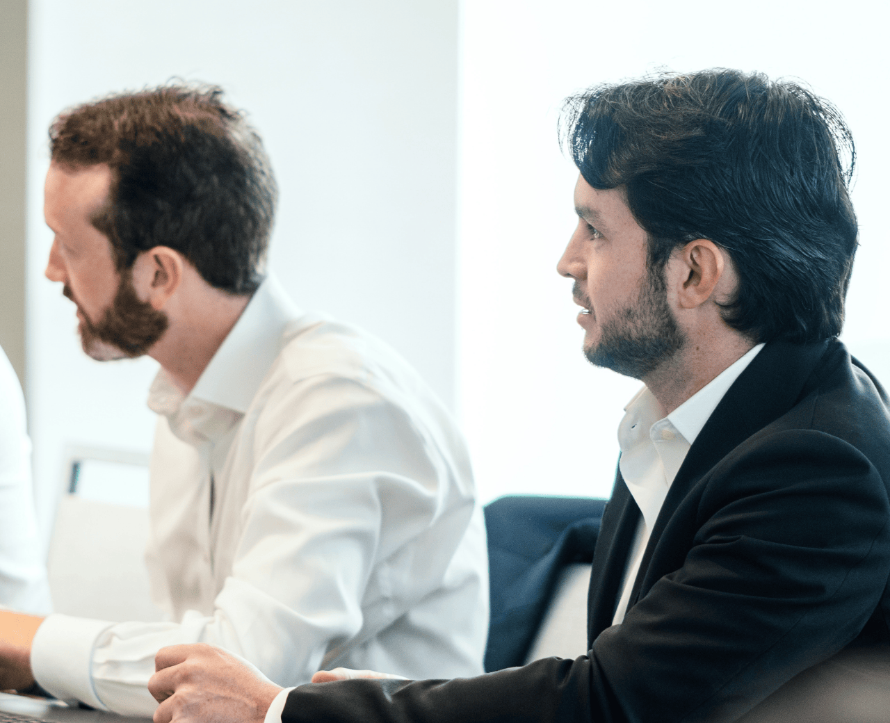 Two TPG cybersecurity consultants listening intently to their client.