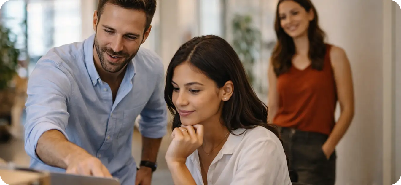 Employee demonstrating company values by mentoring coworker at work