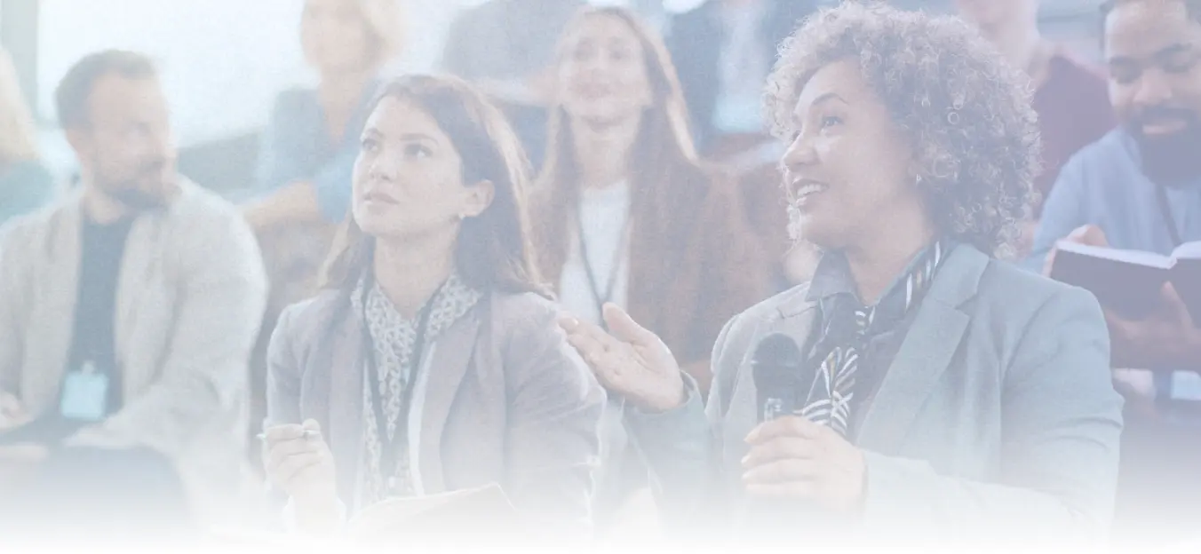 Employees engaged at a workplace conference or seminar illustrating professional development as a manager appreciation idea