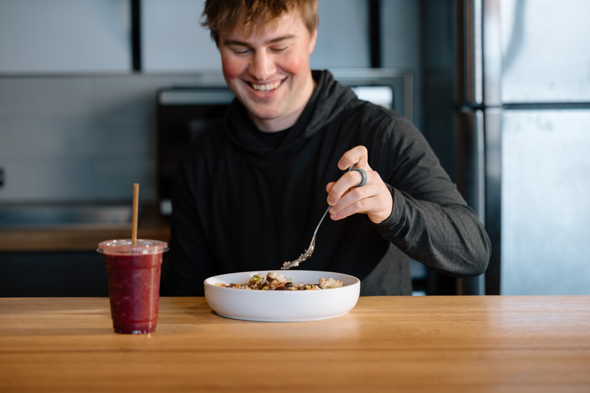 College athlete fueling recovery with a healthy meal and protein smoothie — Rise Nutrition performance nutrition coaching.
