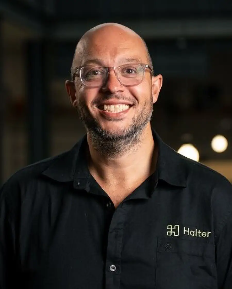 Andrew Fraser — a bald man with glasses and a trimmed beard, wearing a black Halter-branded shirt.