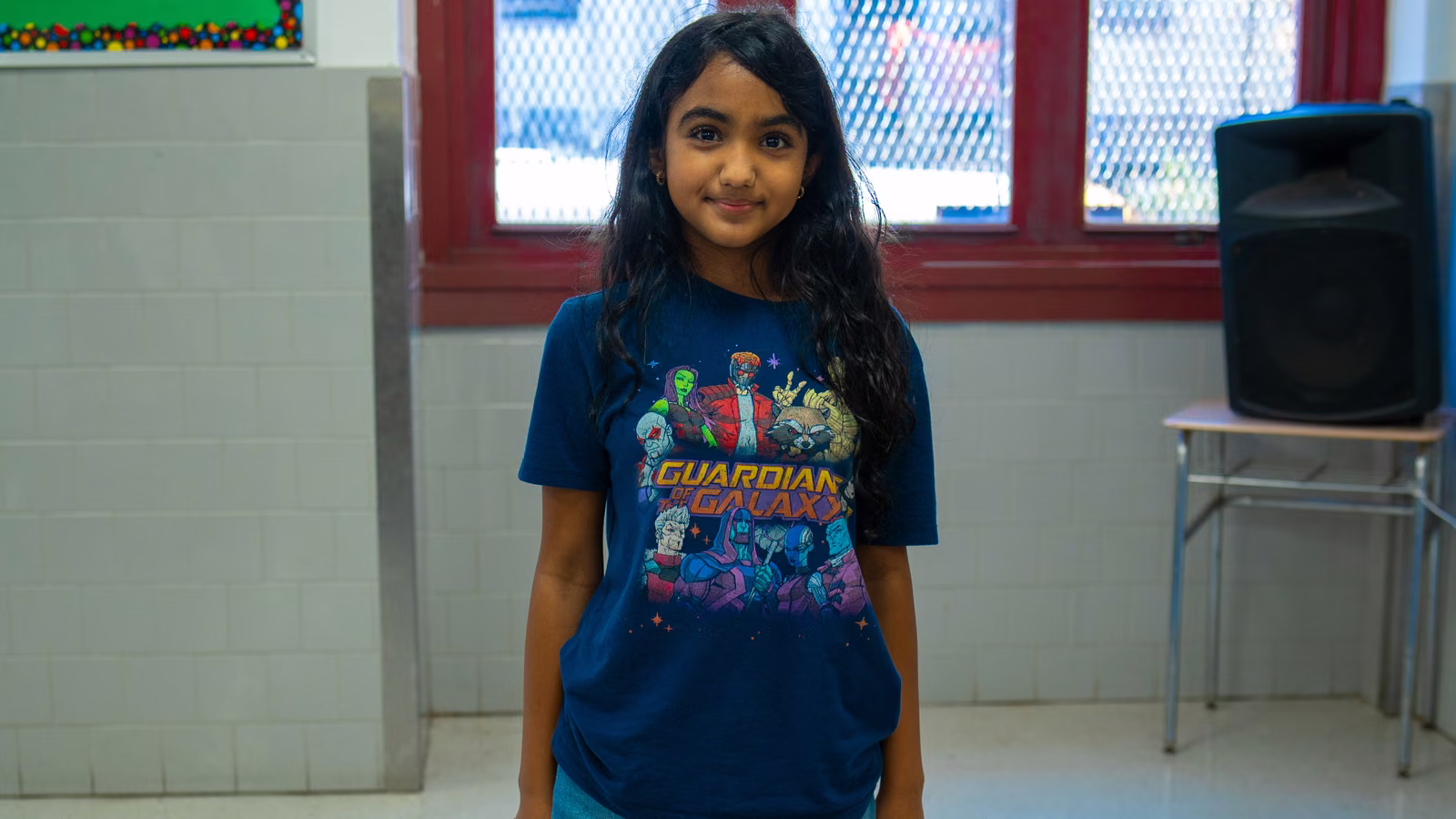 Student smiling in a Guardians of the Galaxy t-shirt