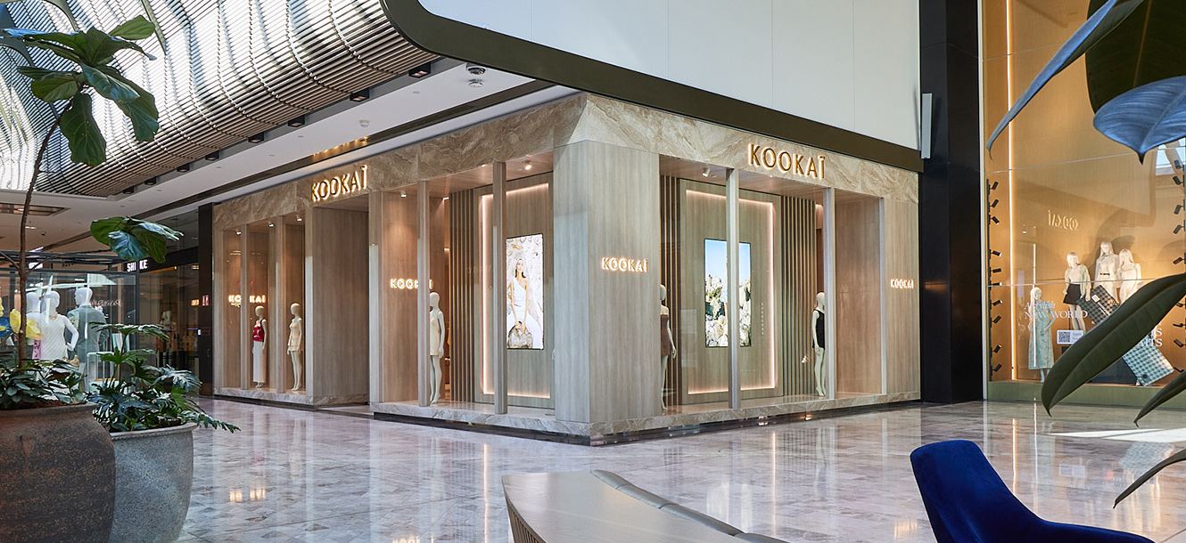 Kookai store exterior at Westfield Carousel shopping centre with illuminated signage and ring sculpture